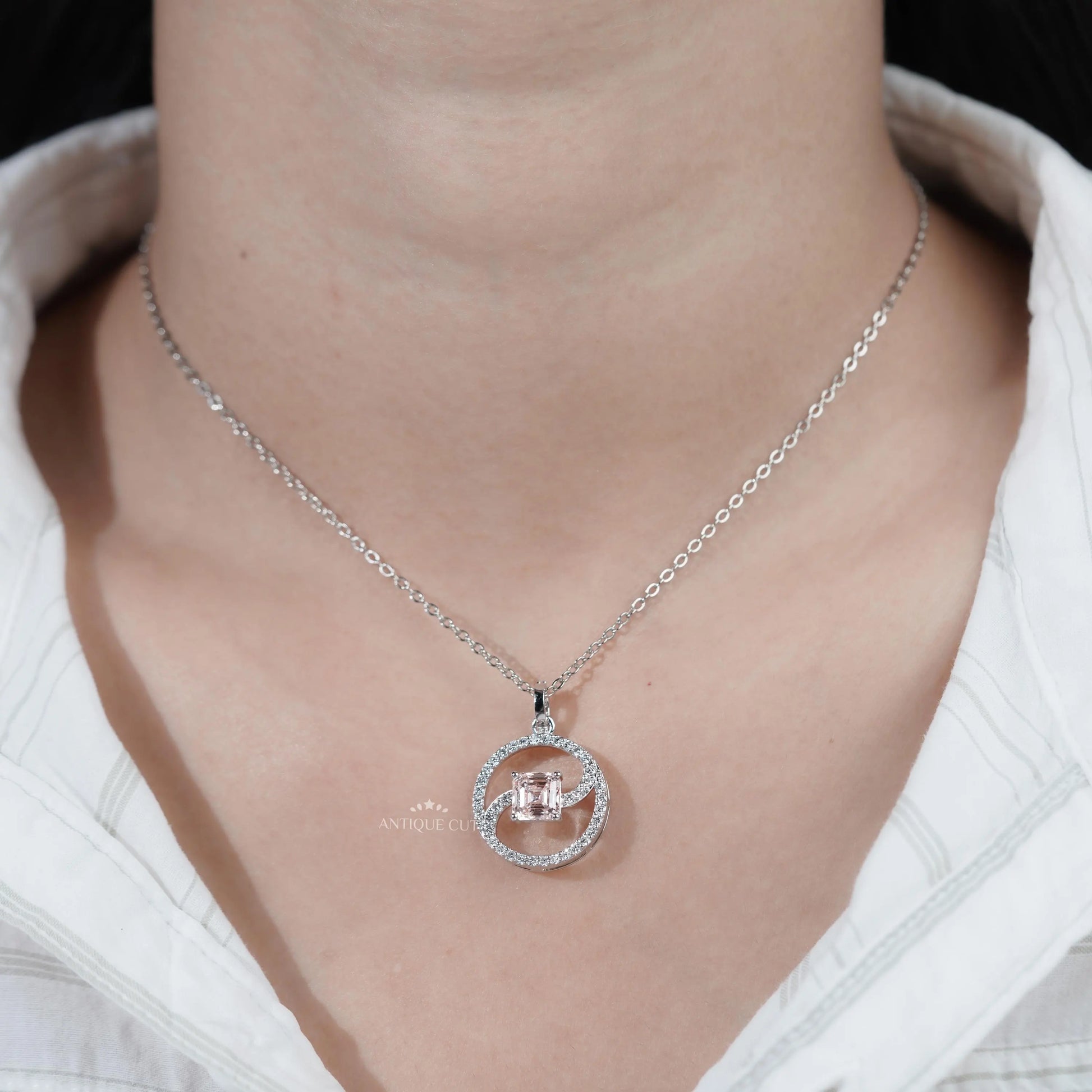 Asscher cut diamond pendant with swirl frame