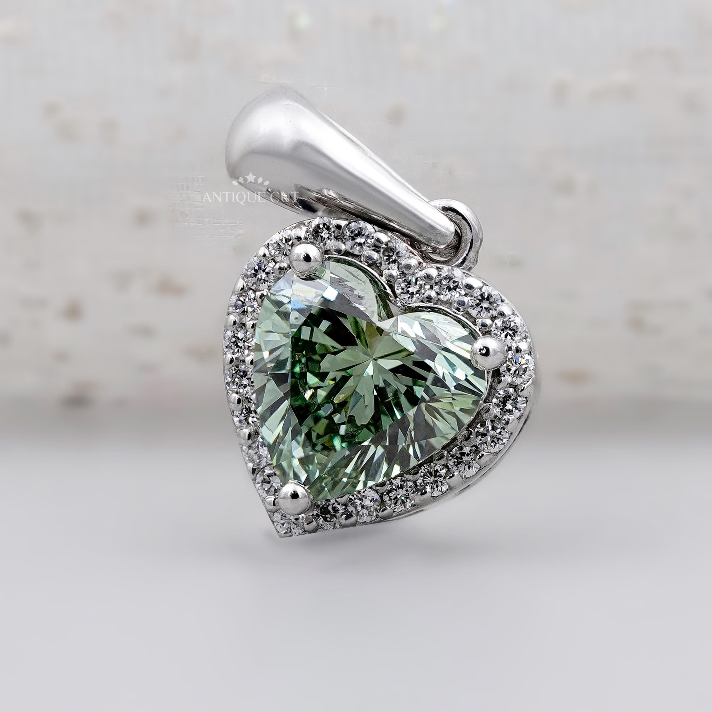 Green heart shaped diamond pendant with halo