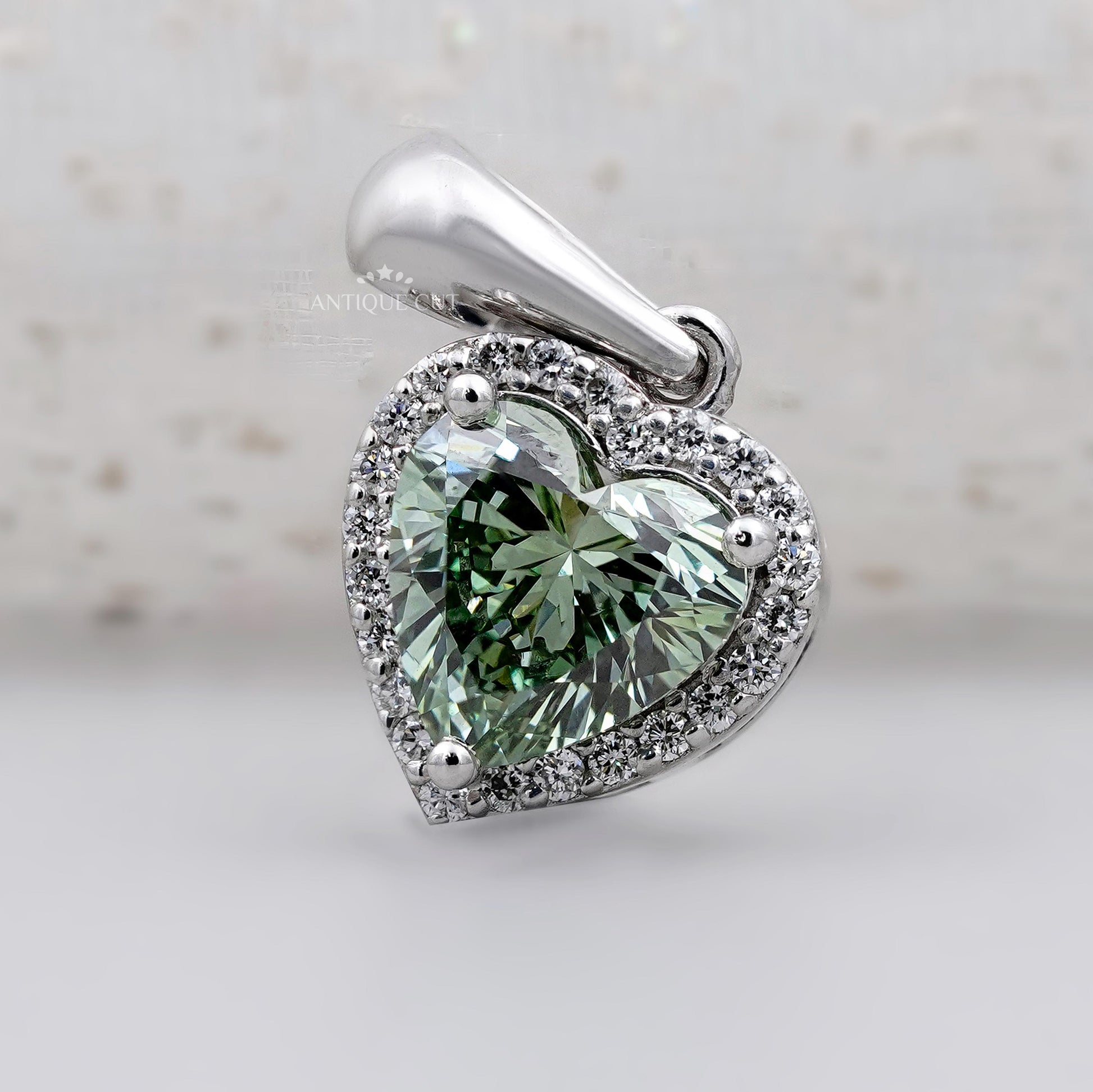 Green heart shaped diamond pendant with halo