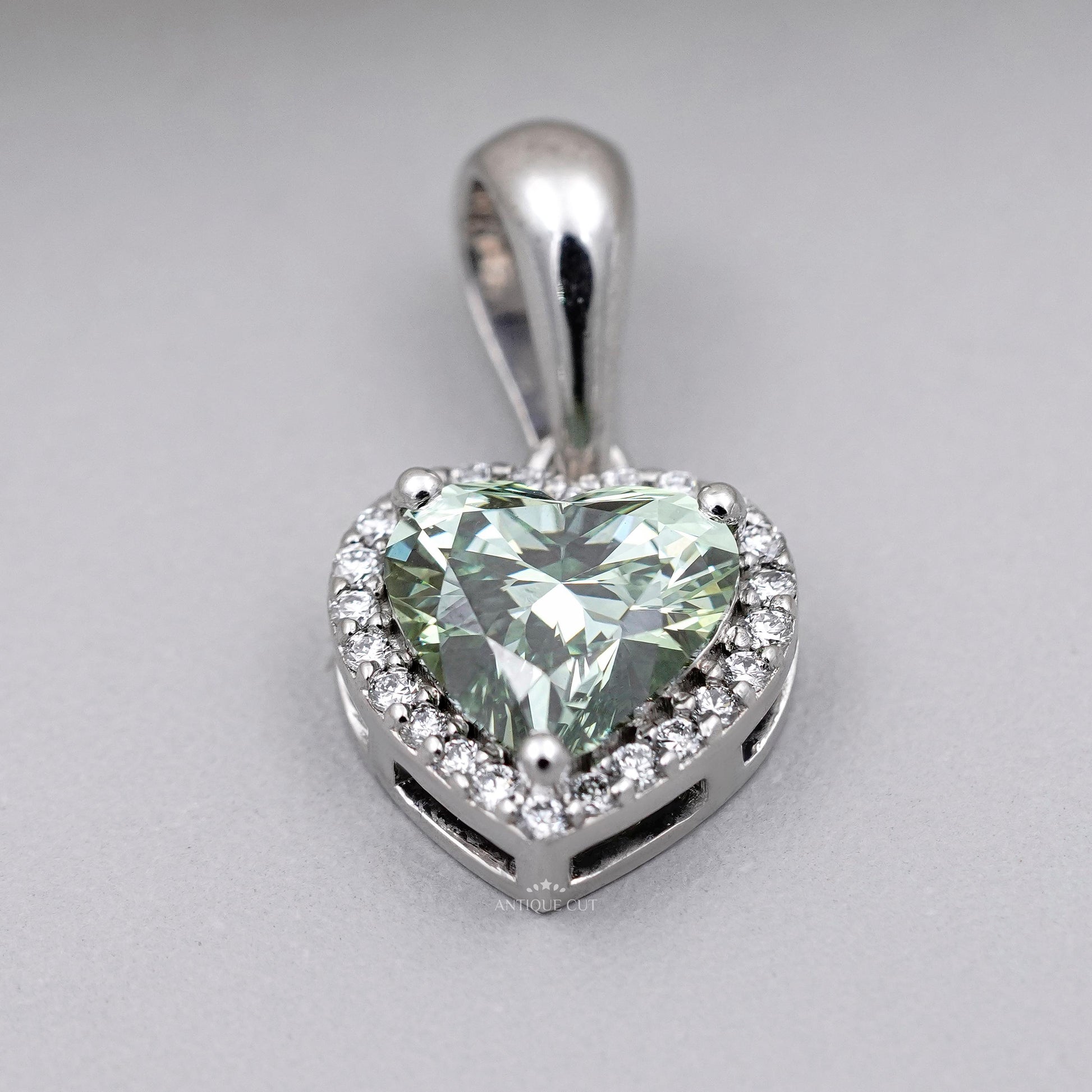 Elegant green heart diamond halo pendant in white gold