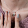Modern halo pendant with green diamond