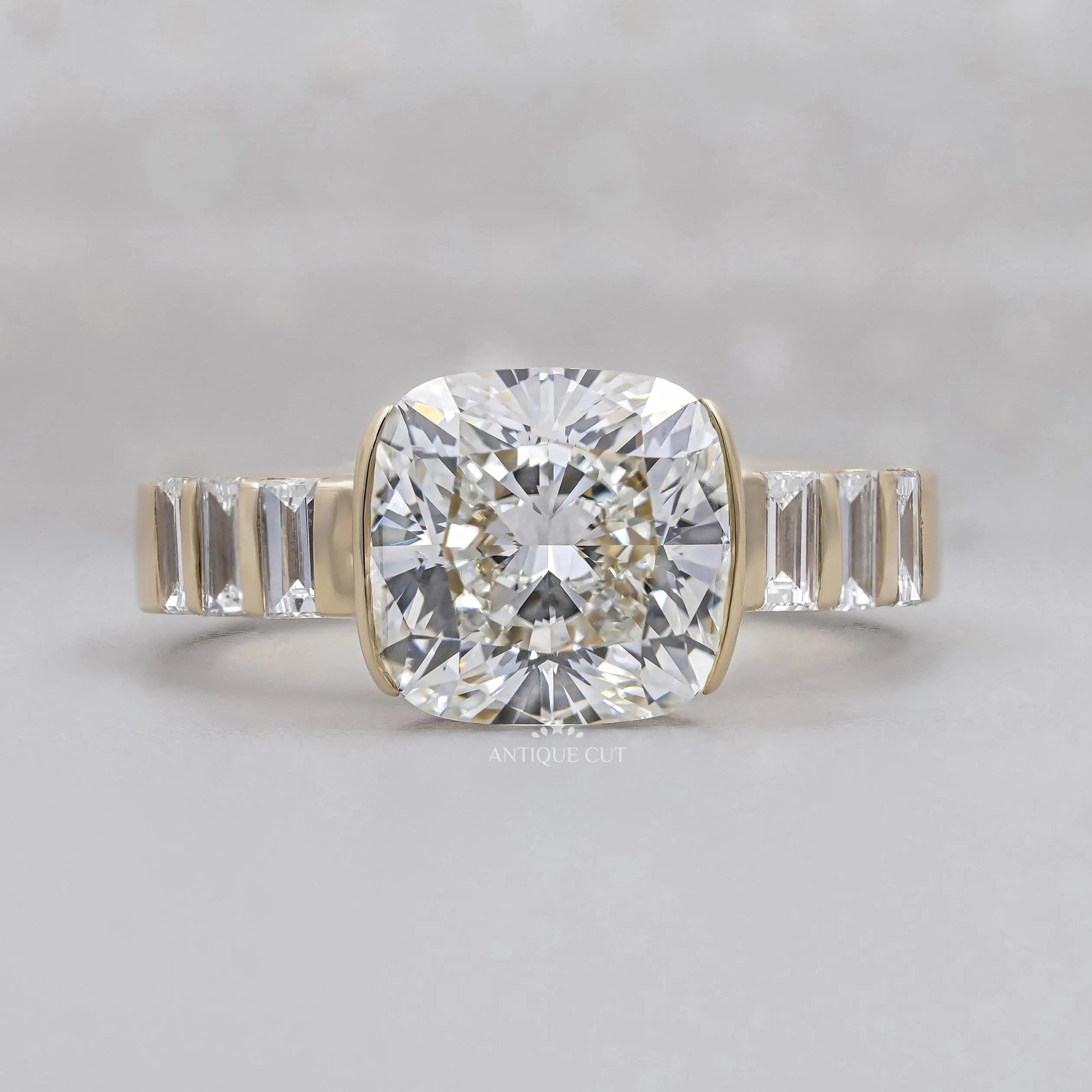 East West Cushion Cut Engagement Ring With Half Bezel Yellow Gold
