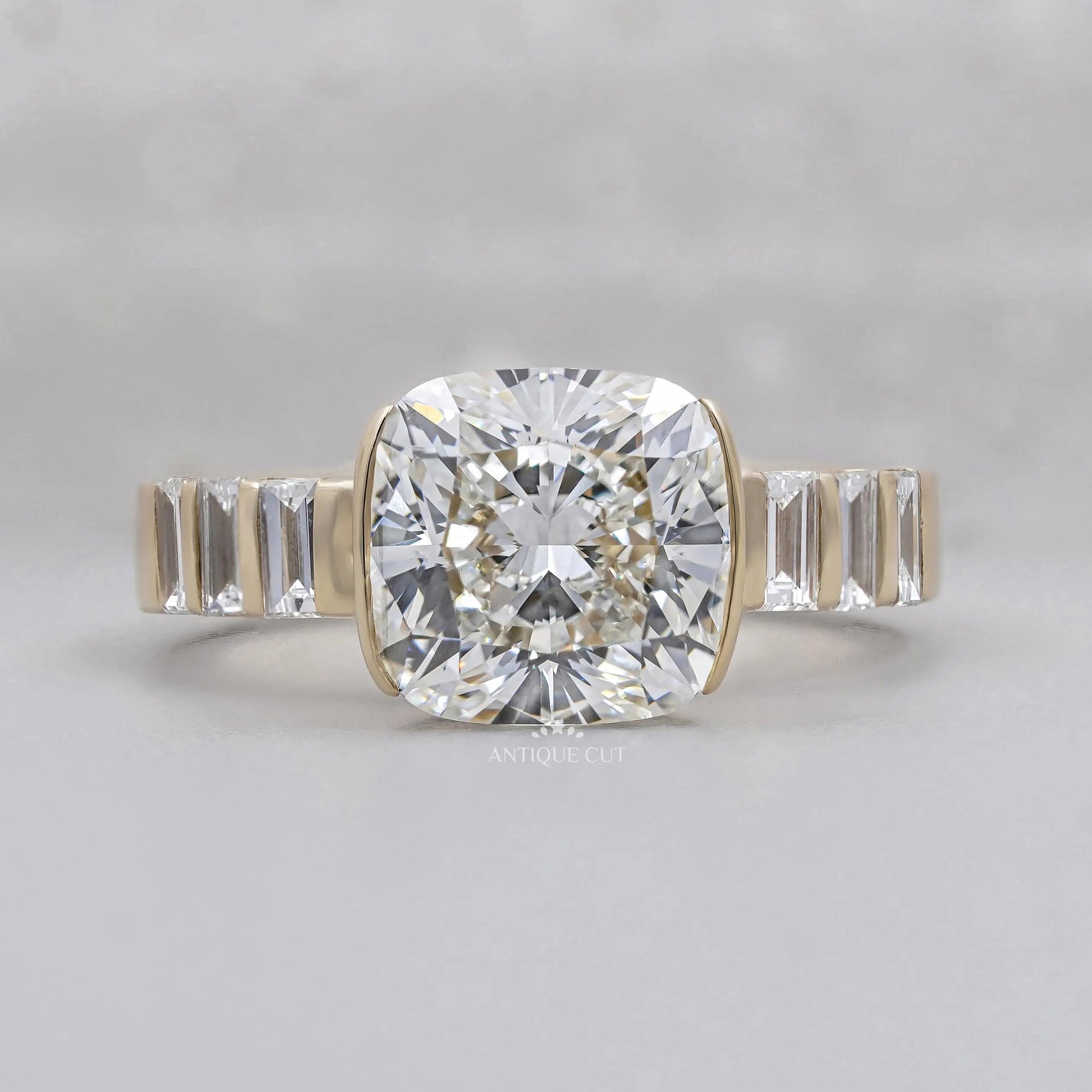 East West Cushion Cut Engagement Ring With Half Bezel Yellow Gold