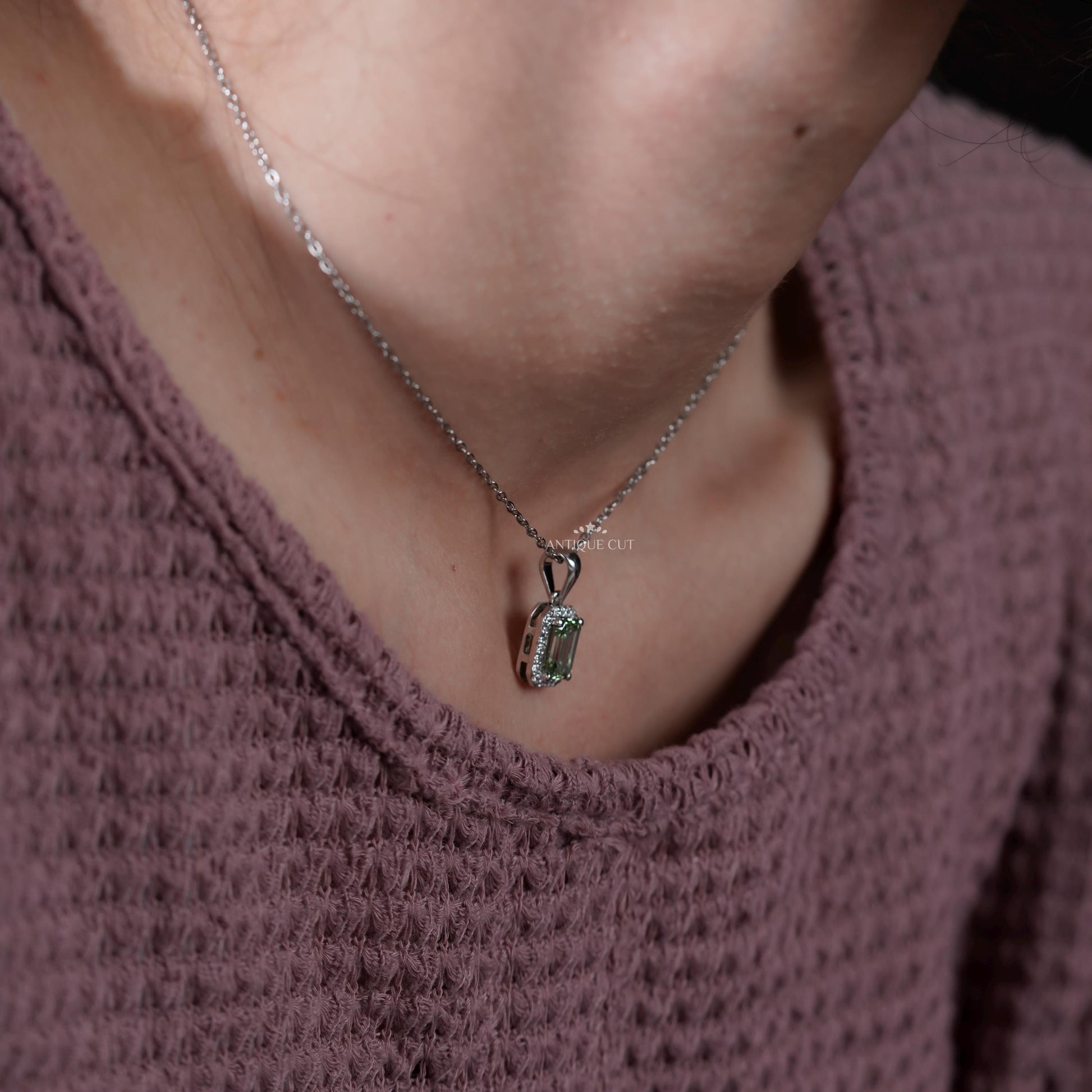 Elegant white gold emerald halo necklace