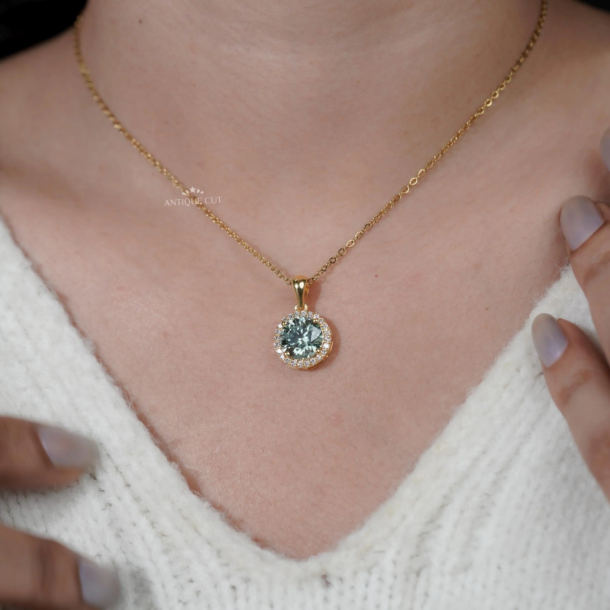 Round green diamond pendant with surrounding halo stones