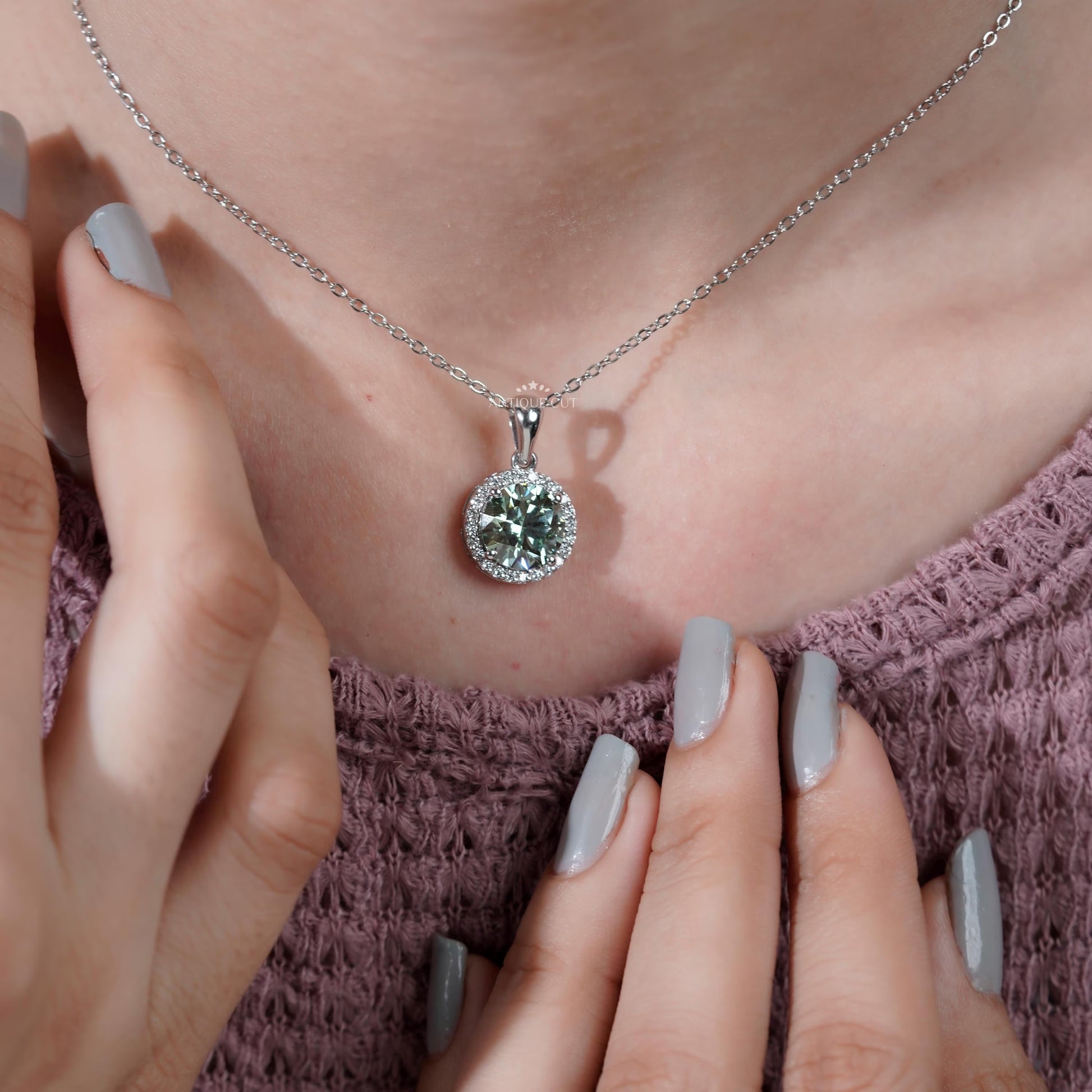 Elegant white gold halo pendant with green diamond