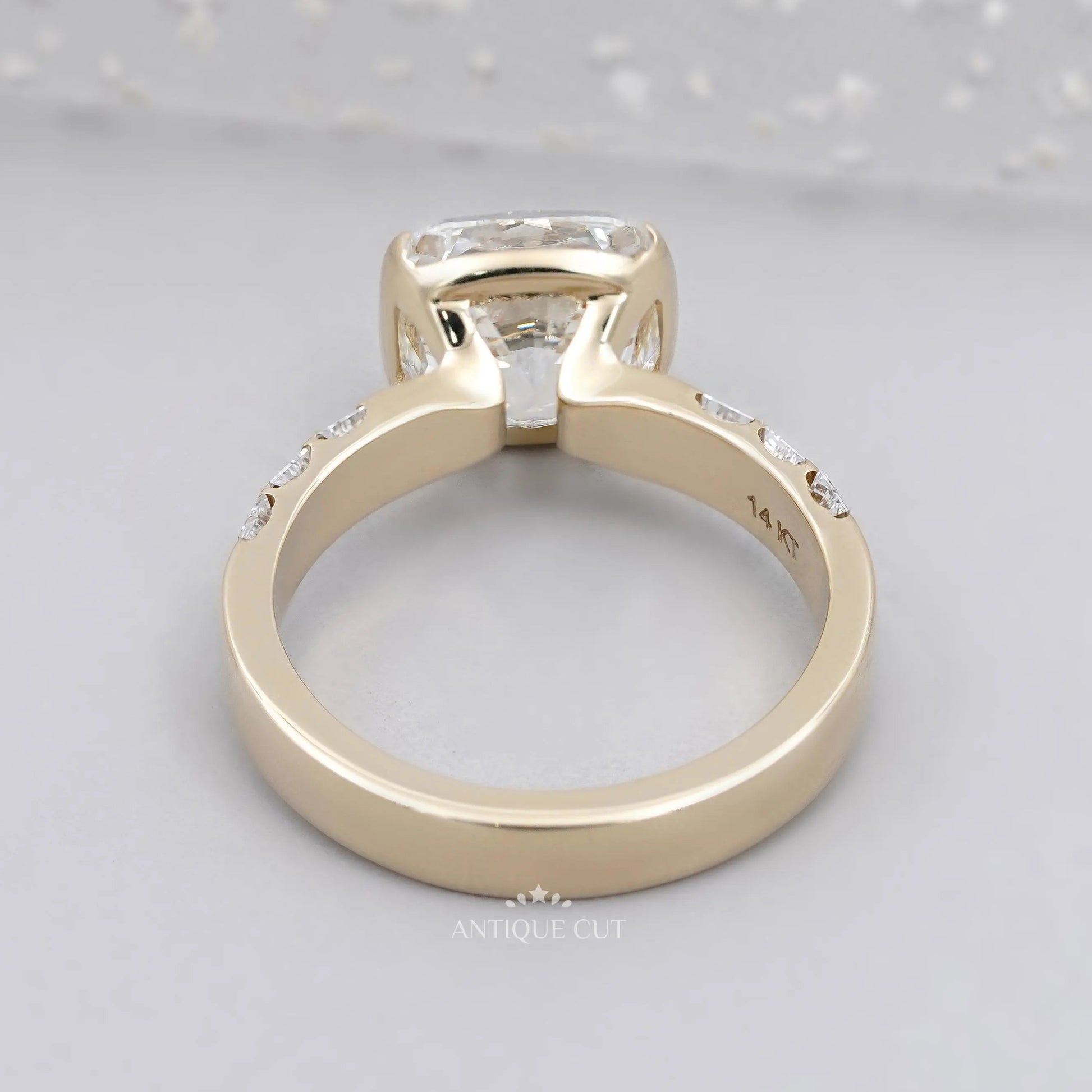East West cushion diamond solitaire ring in yellow gold