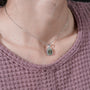 Regal halo emerald pendant in gold