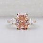 Pink cushion diamond three stone ring with pear side stones