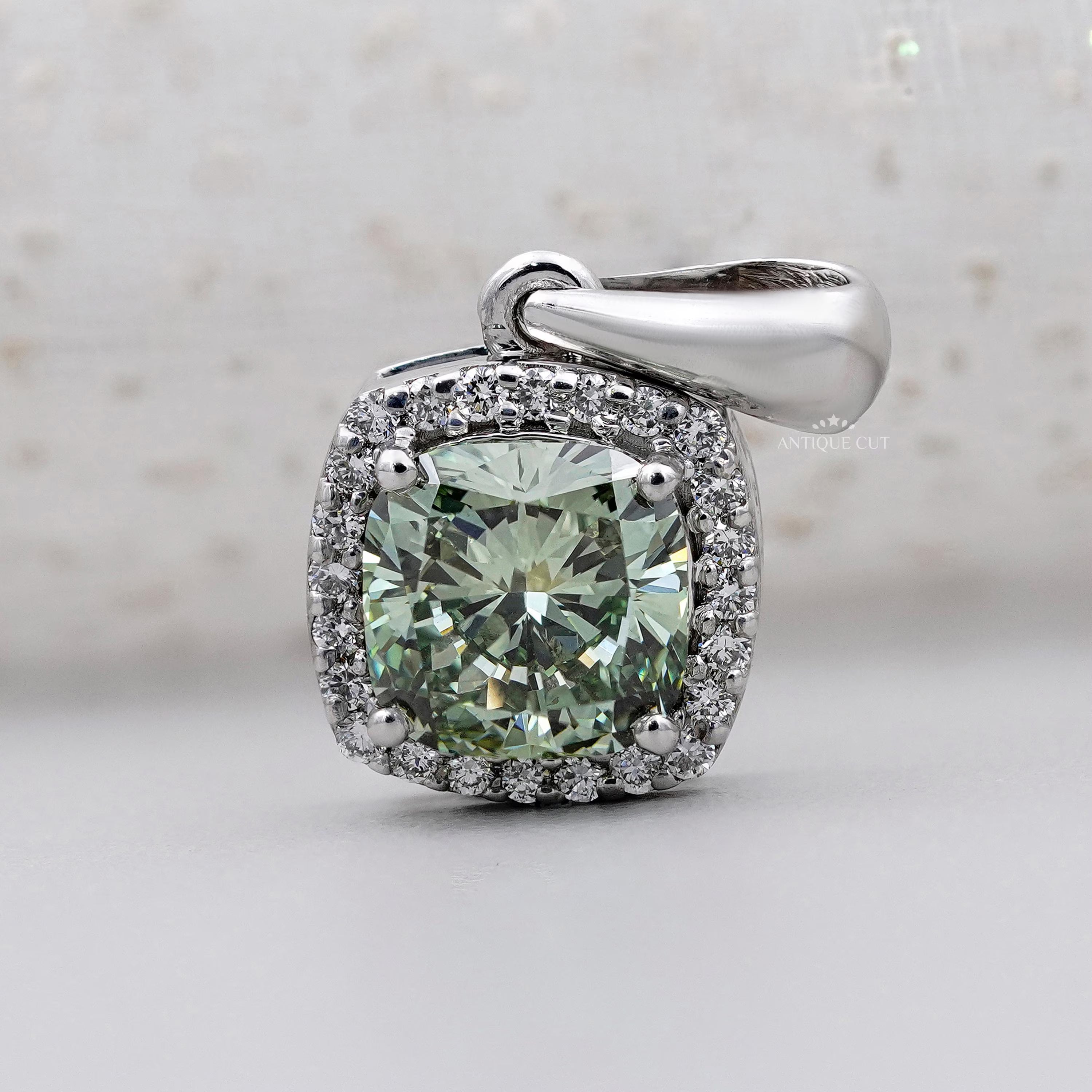 Cushion cut green moissanite halo pendant in white gold