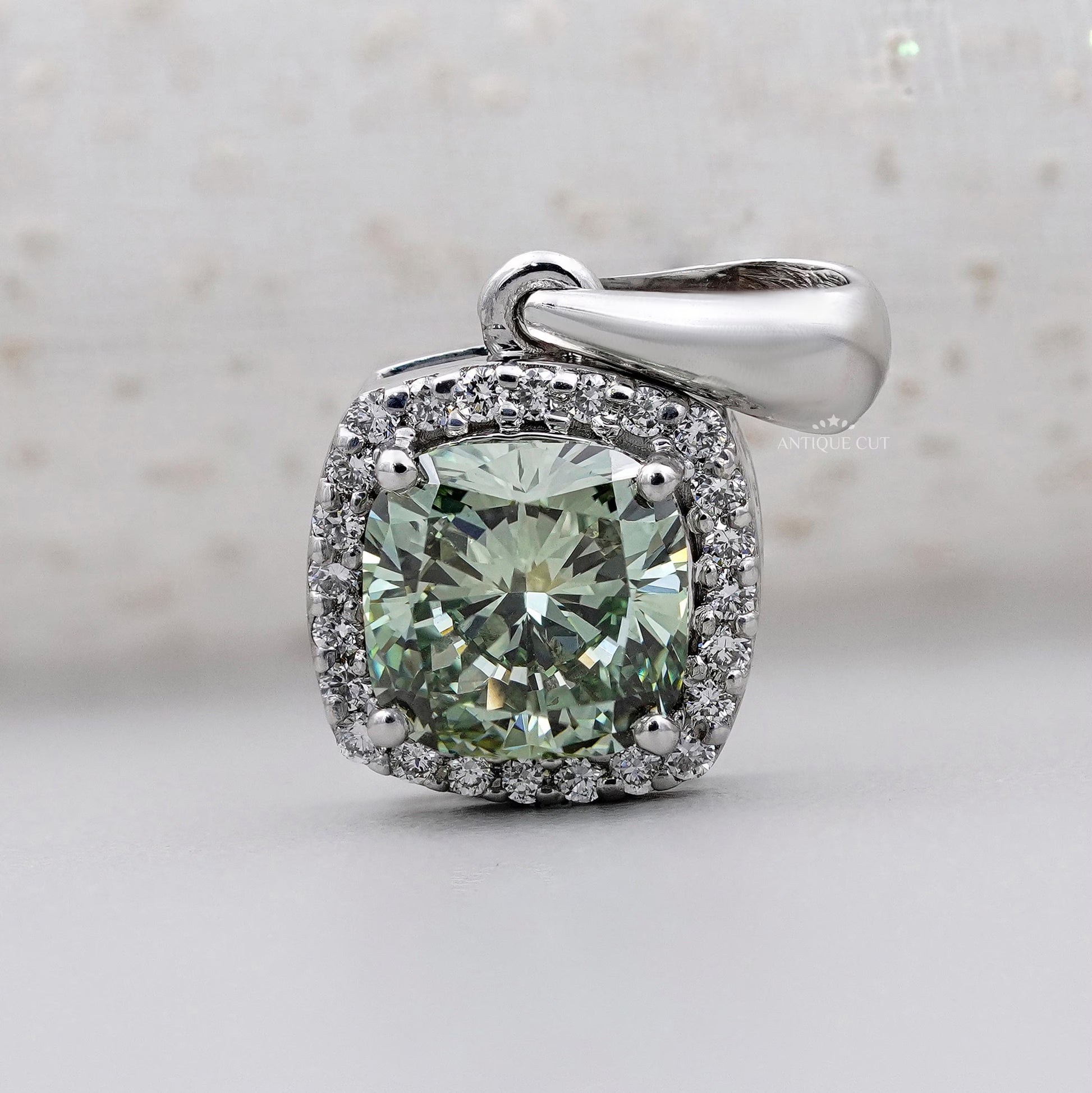 Cushion cut green moissanite halo pendant in white gold