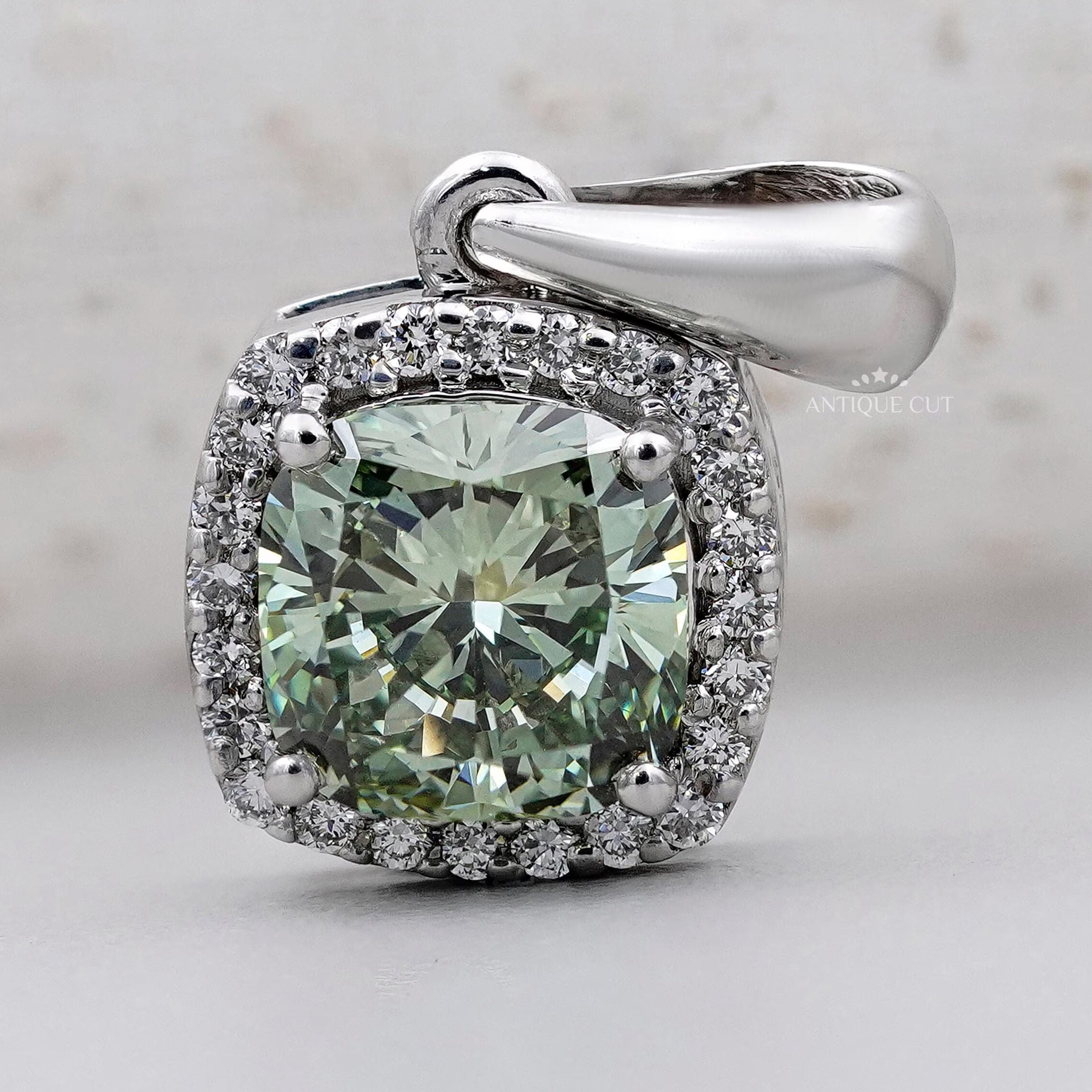 Elegant cushion cut green halo pendant with IGI certified diamond