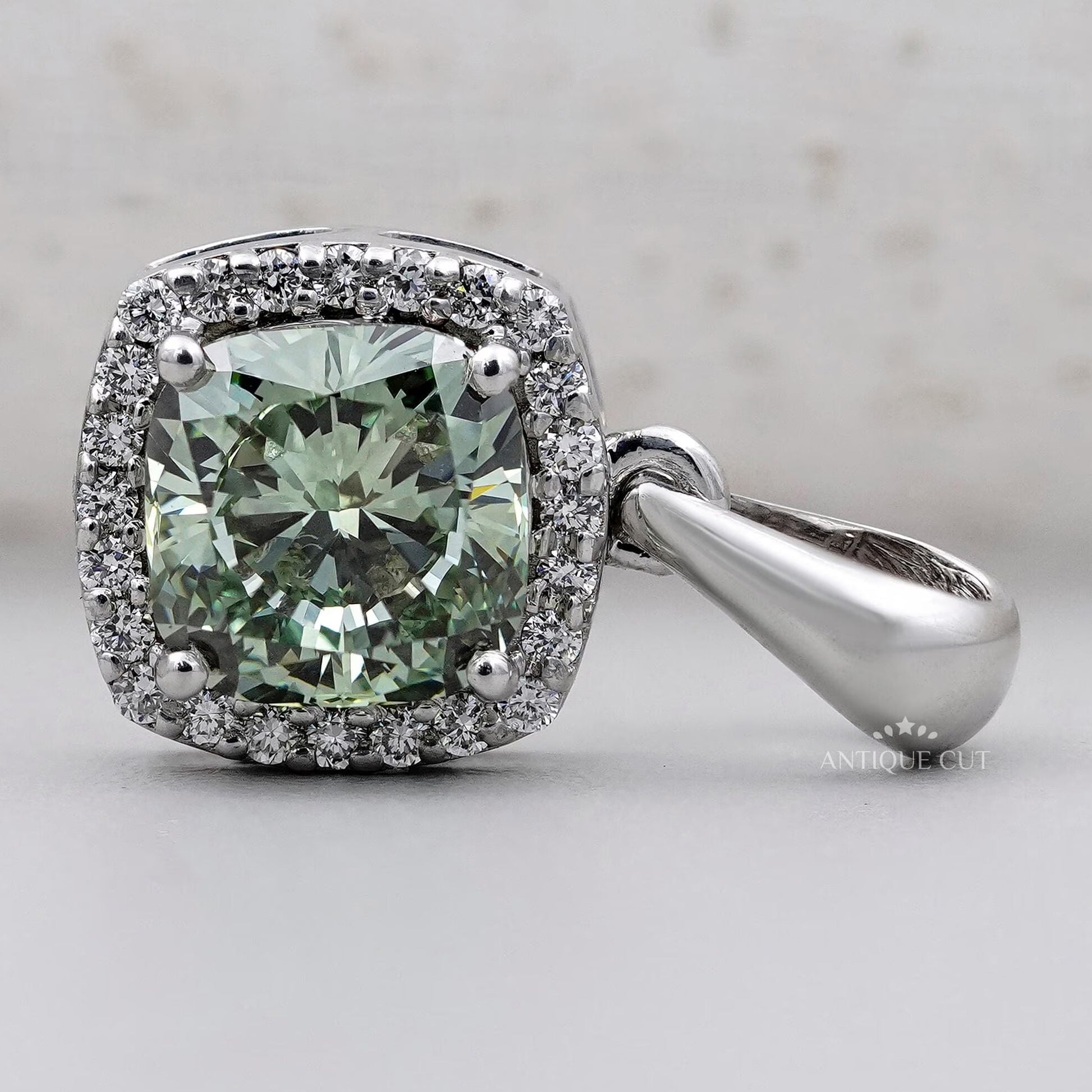 Cushion cut green gemstone pendant in fine jewelry setting