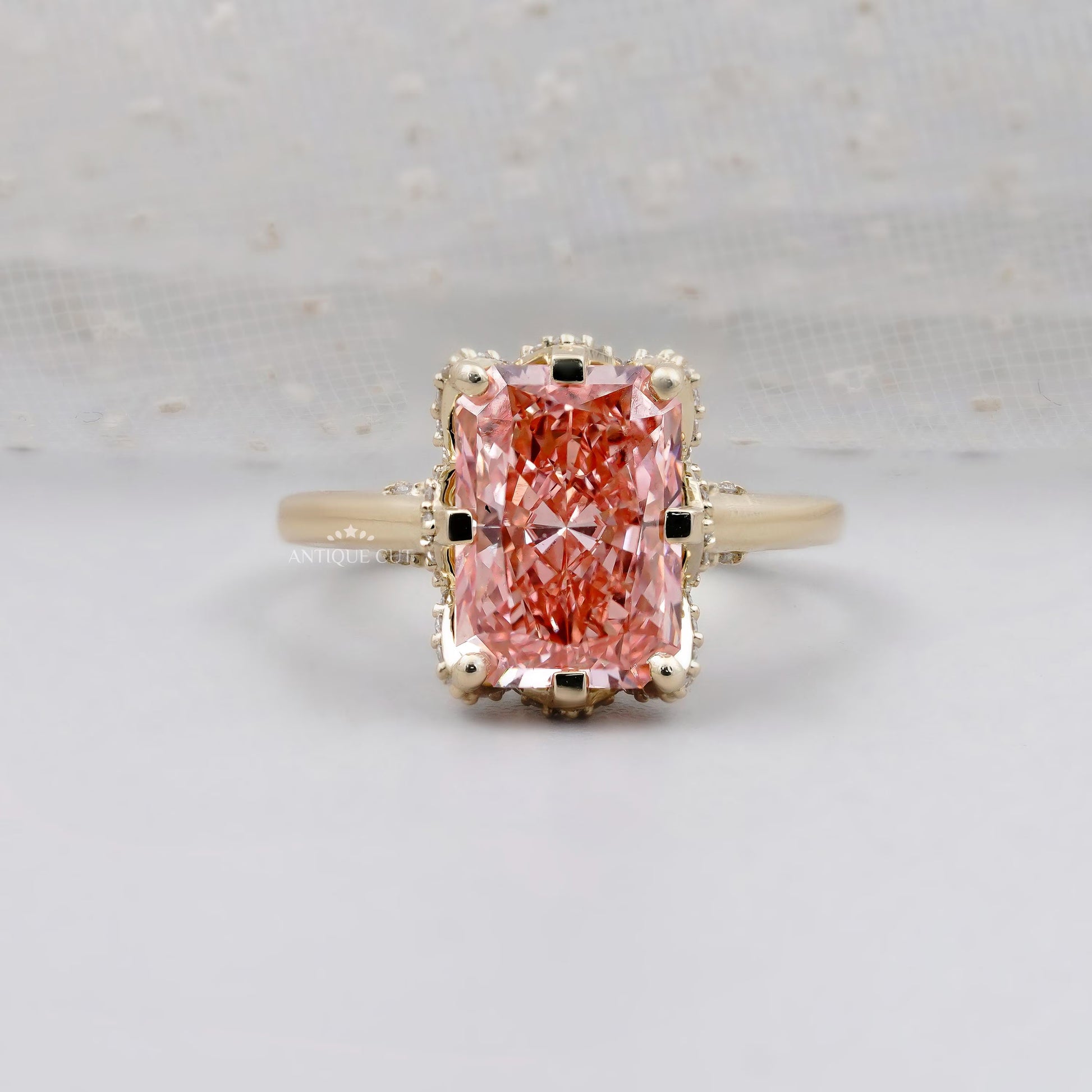 Radiant pink diamond hidden halo engagement ring in yellow gold
