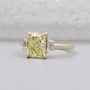 Radiant cut yellow diamond engagement ring with side stones