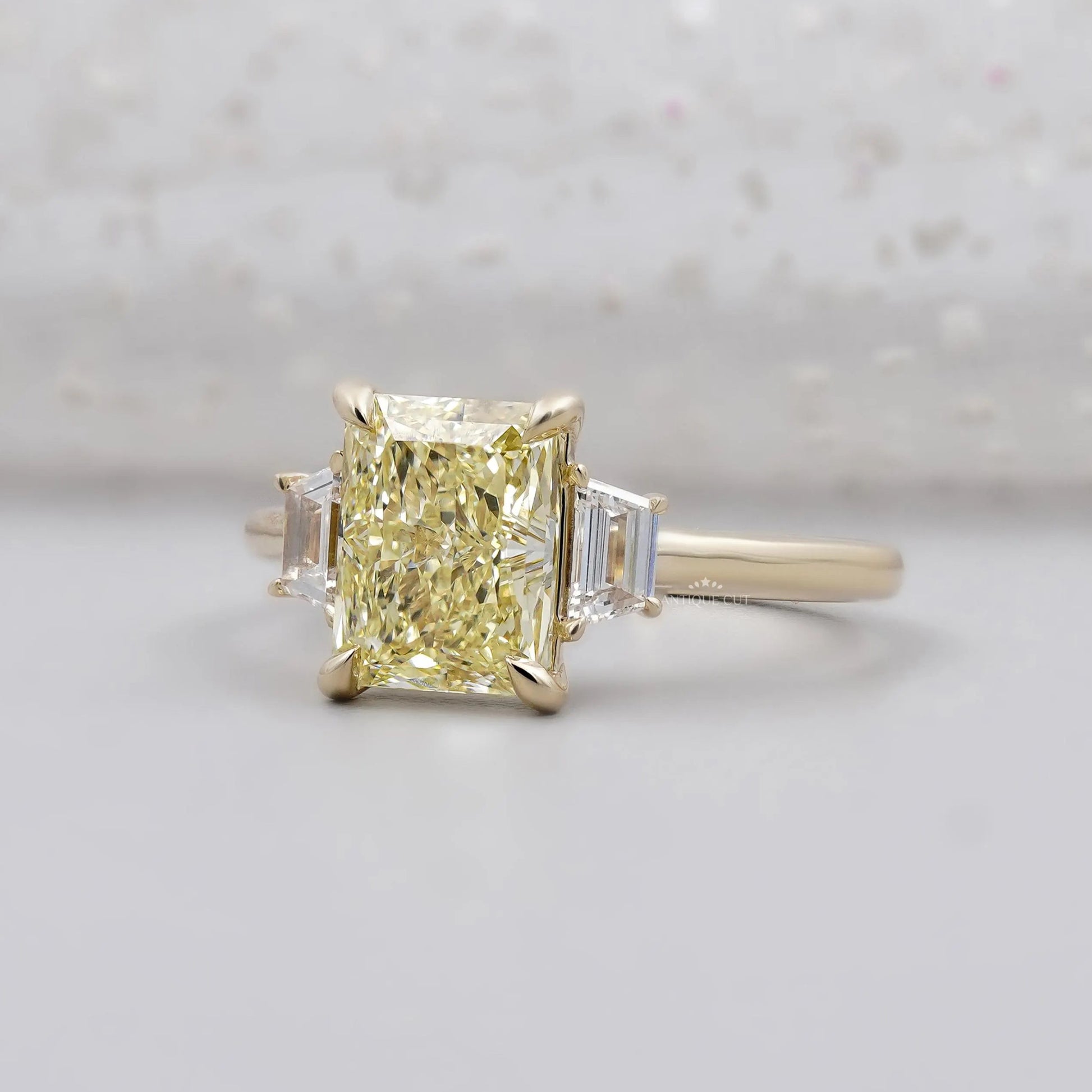 Radiant cut yellow diamond engagement ring with side stones