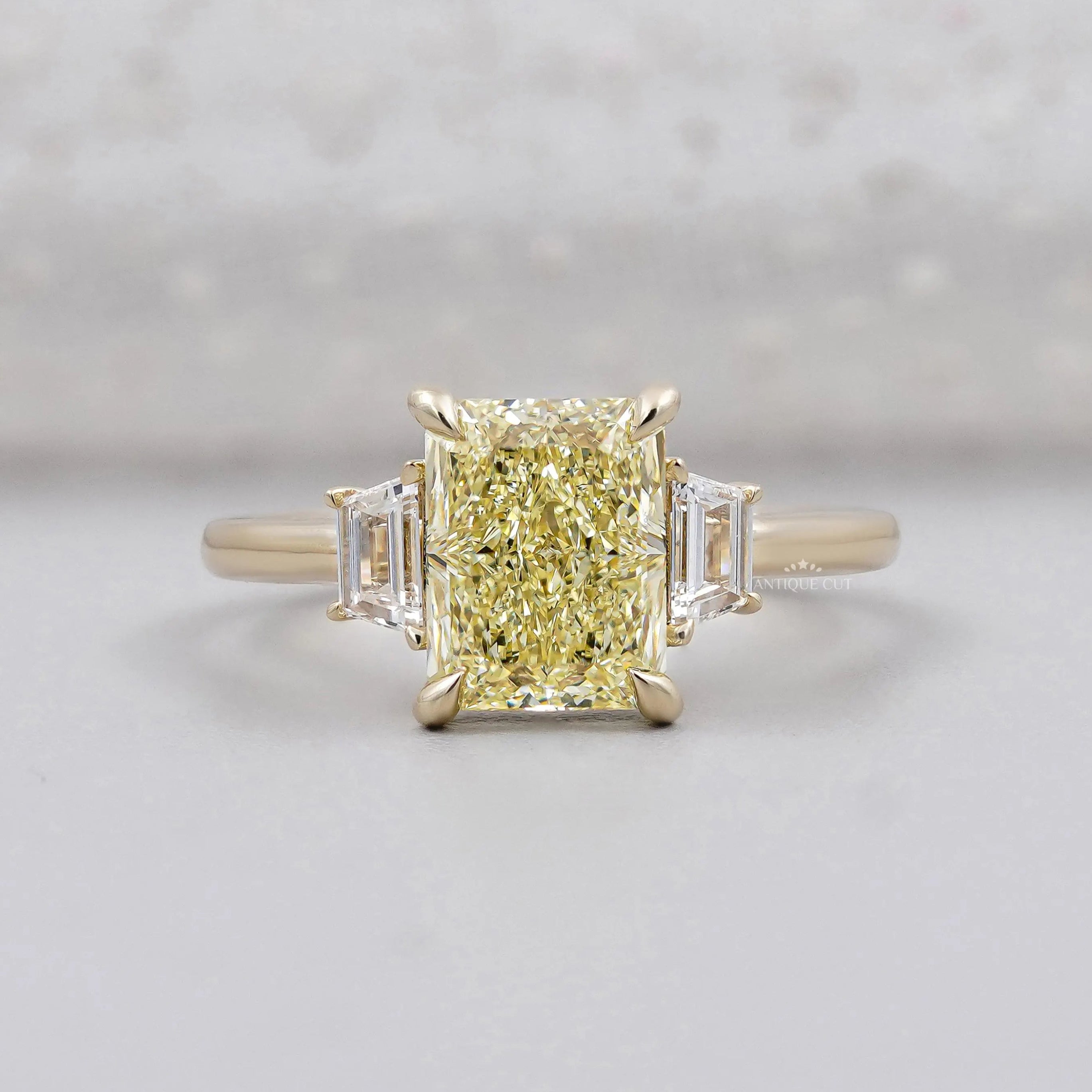 Radiant Fancy Yellow Diamond With Trapezoid Side Stone Ring IGI Certified
