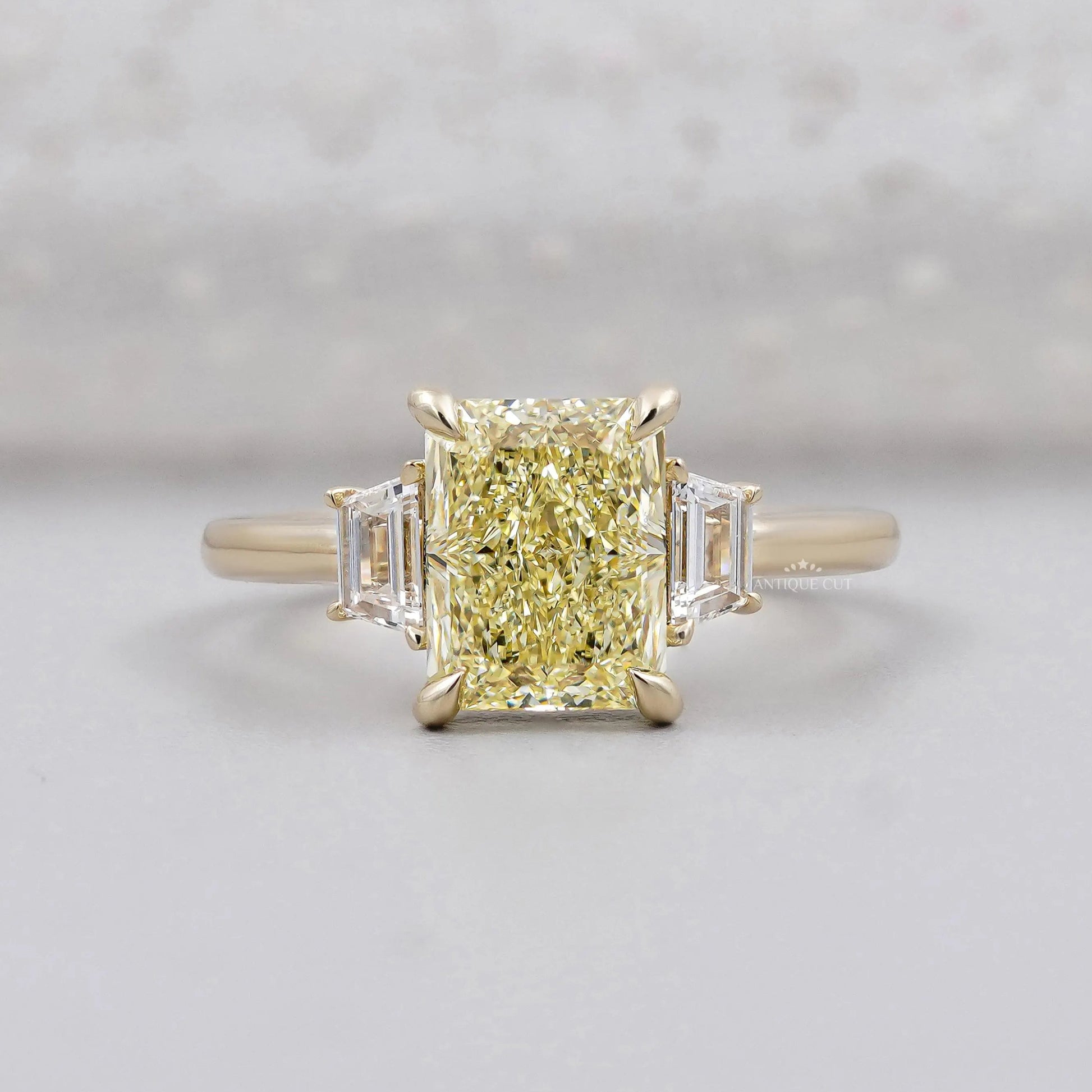 Radiant Fancy Yellow Diamond With Trapezoid Side Stone Ring IGI Certified