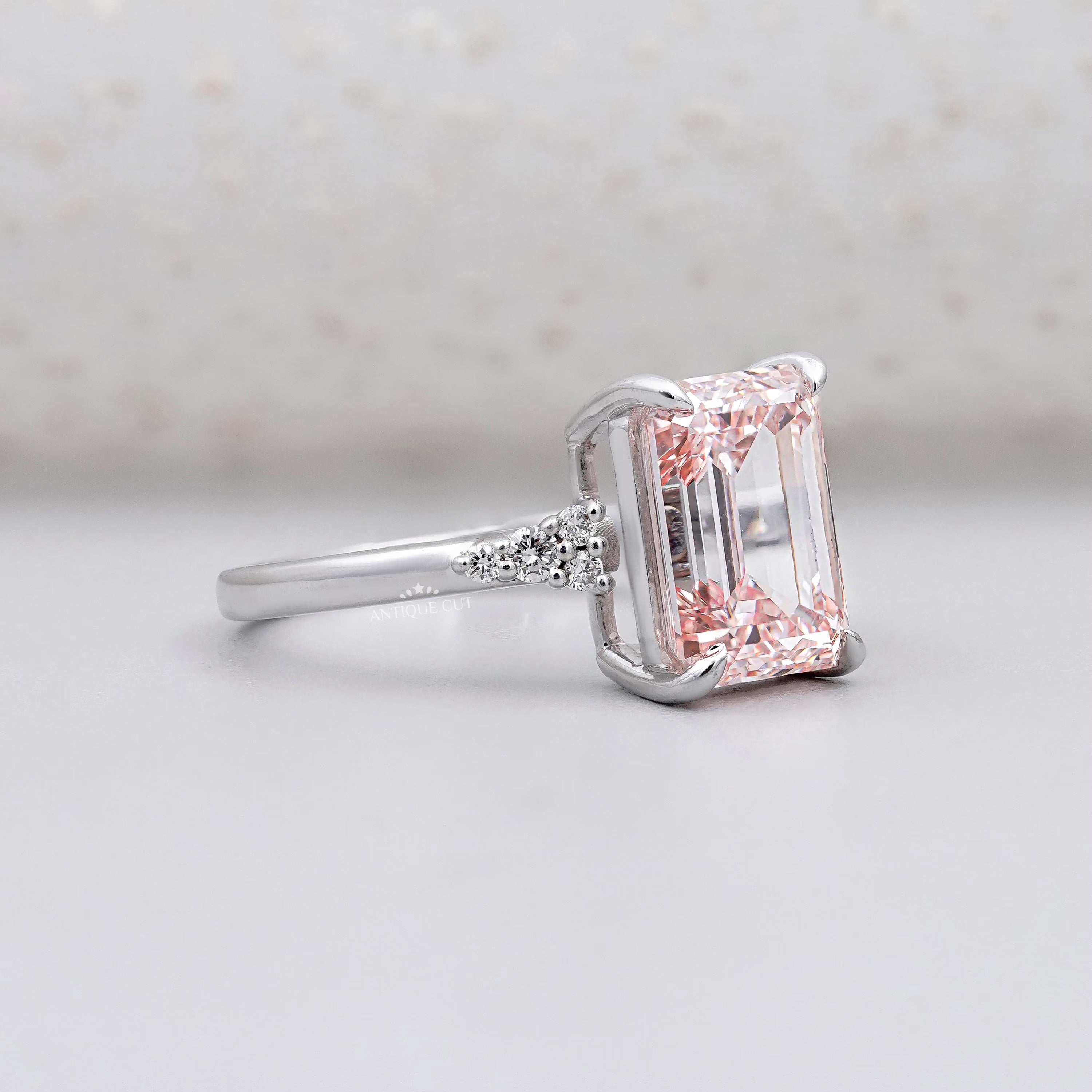 Pink diamond ring with side diamond clusters