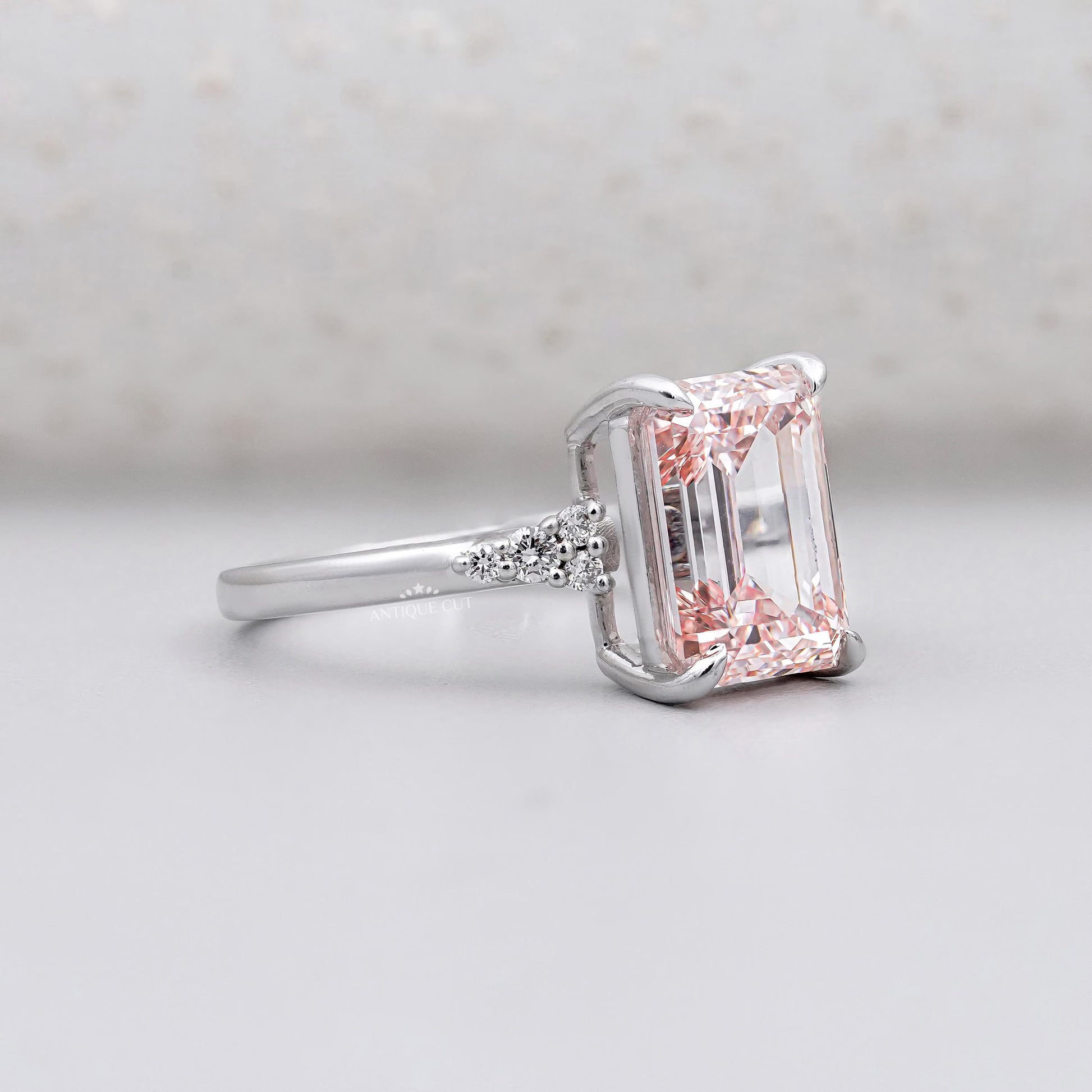 Pink diamond ring with side diamond clusters