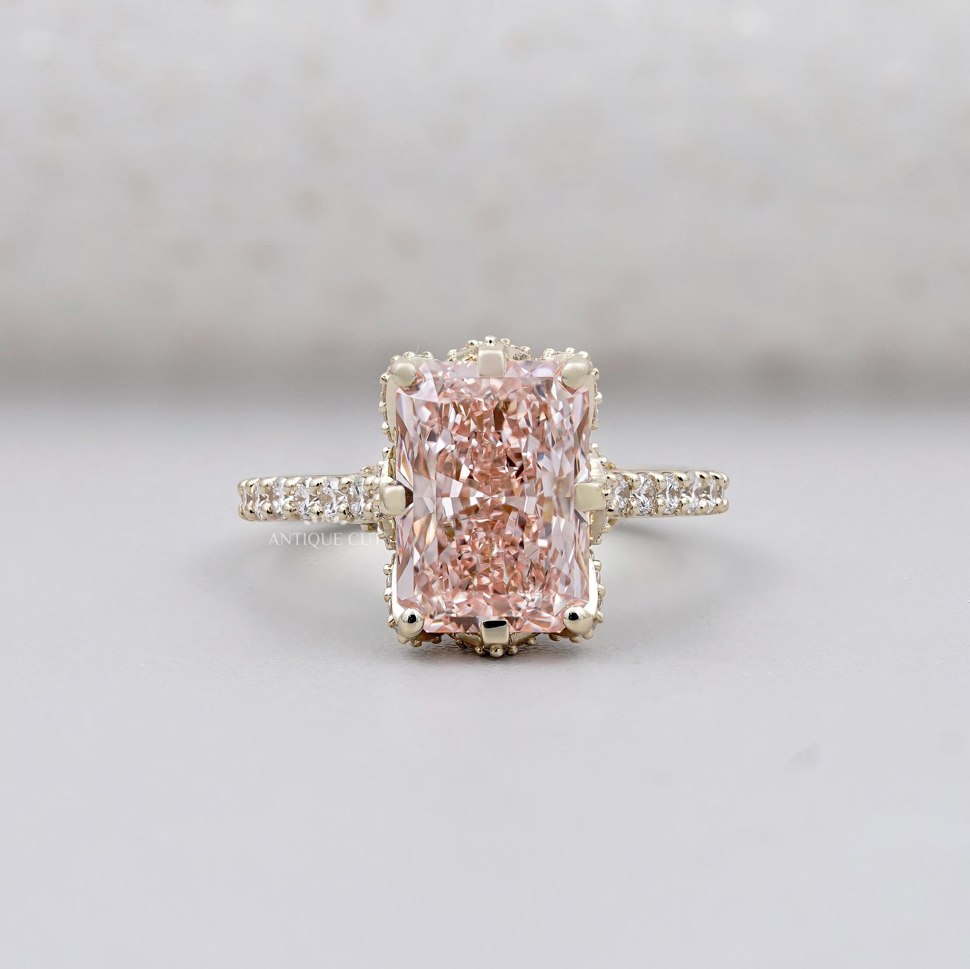 Radiant pink diamond hidden halo engagement ring in yellow gold