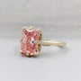 Elegant pink diamond engagement ring with halo setting