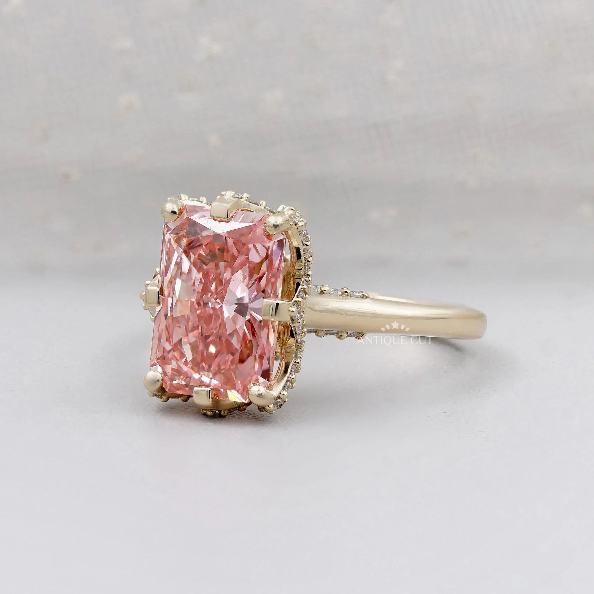 Elegant pink diamond engagement ring with halo setting