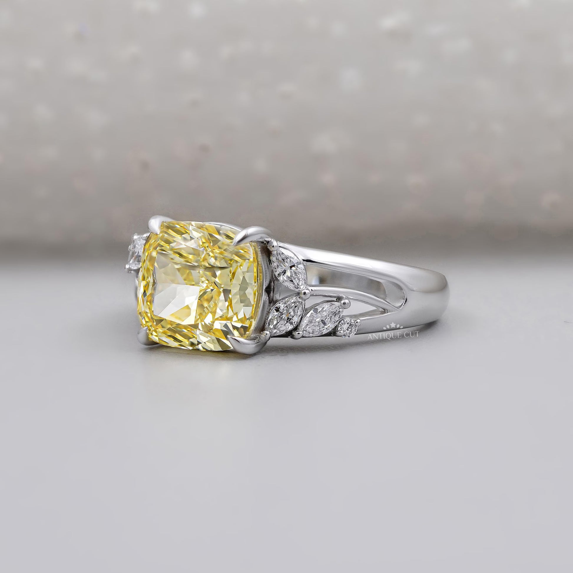 Fancy yellow cushion diamond ring in white gold setting