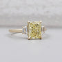 Fancy yellow radiant cut diamond ring with trapezoid side stones