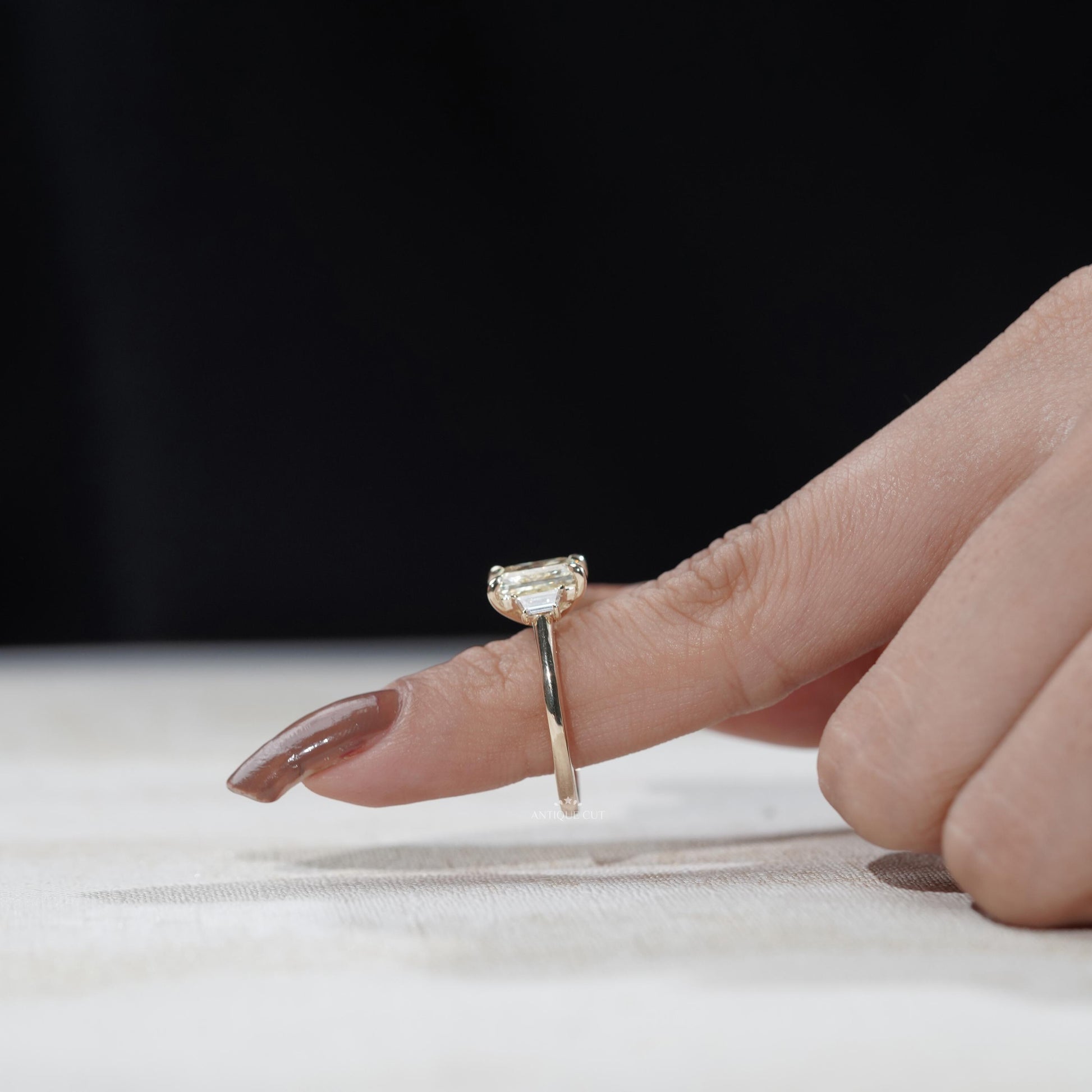 Modern yellow gold radiant diamond ring with side stones
