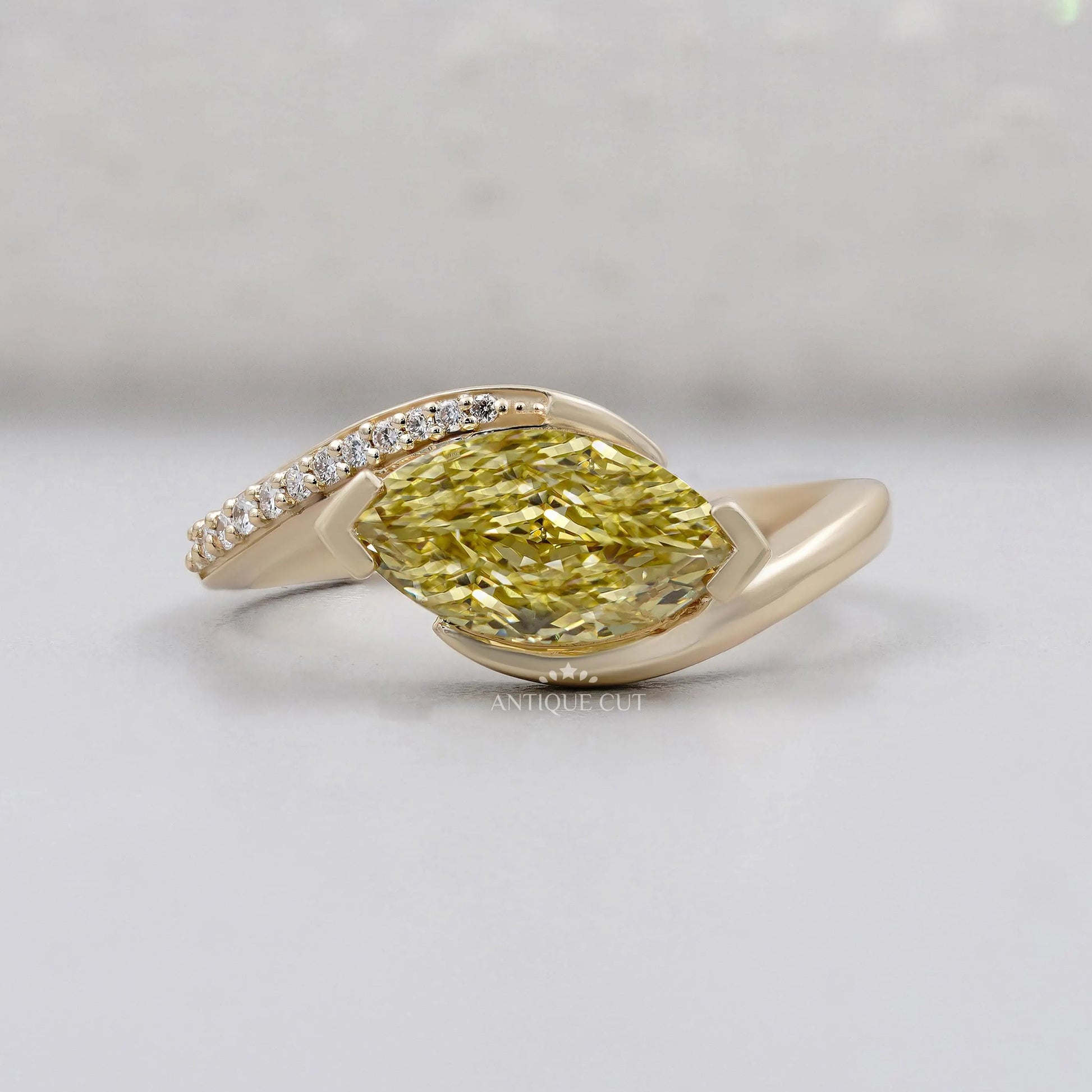 Marquise Cut Fancy Yellow Diamond Bypass Engagement Ring With Round Side Stones IGI Certified