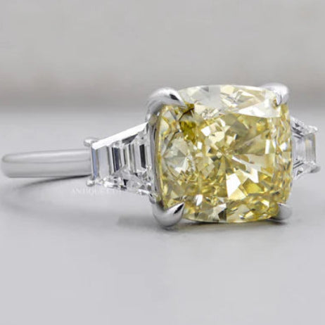 Fancy yellow cushion cut diamond three stone engagement ring