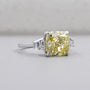 Fancy yellow cushion cut diamond three stone engagement ring