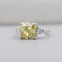Cushion cut yellow diamond ring with tapered baguette side stones