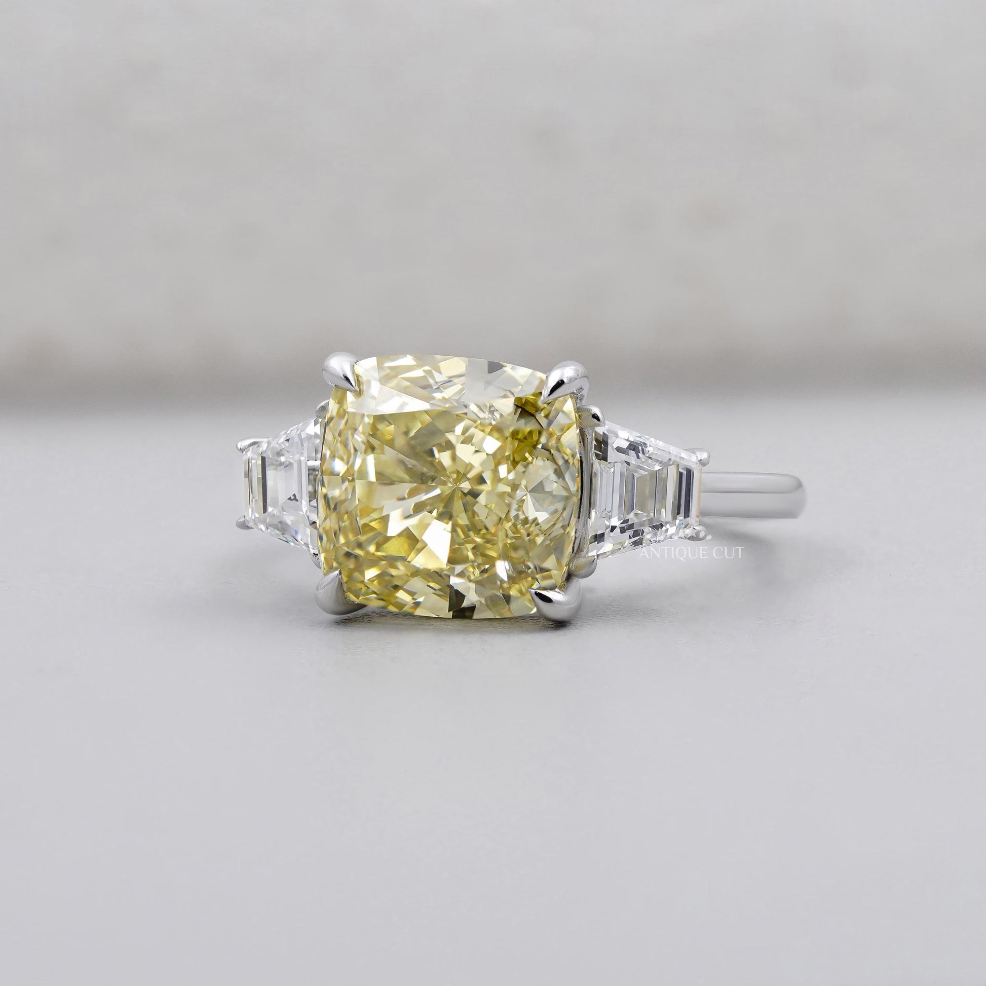 Cushion cut yellow diamond ring with tapered baguette side stones