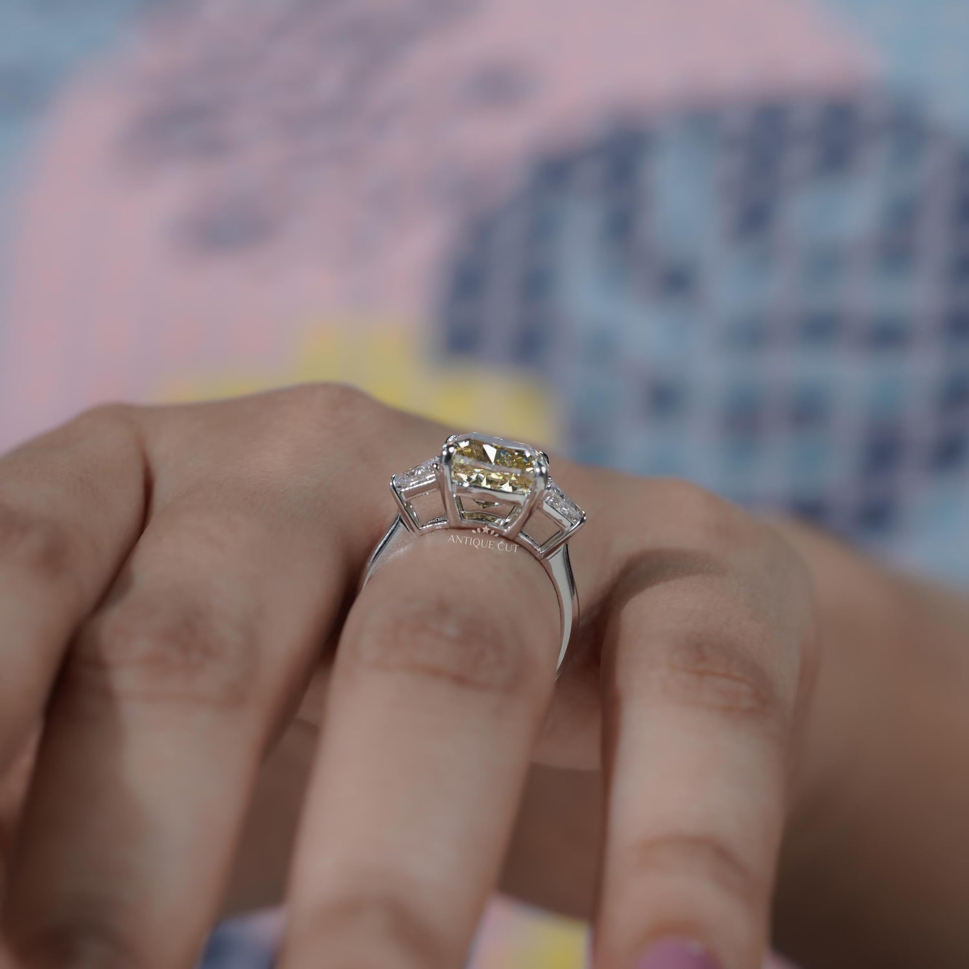 Bridal cushion cut yellow diamond ring with baguette accents