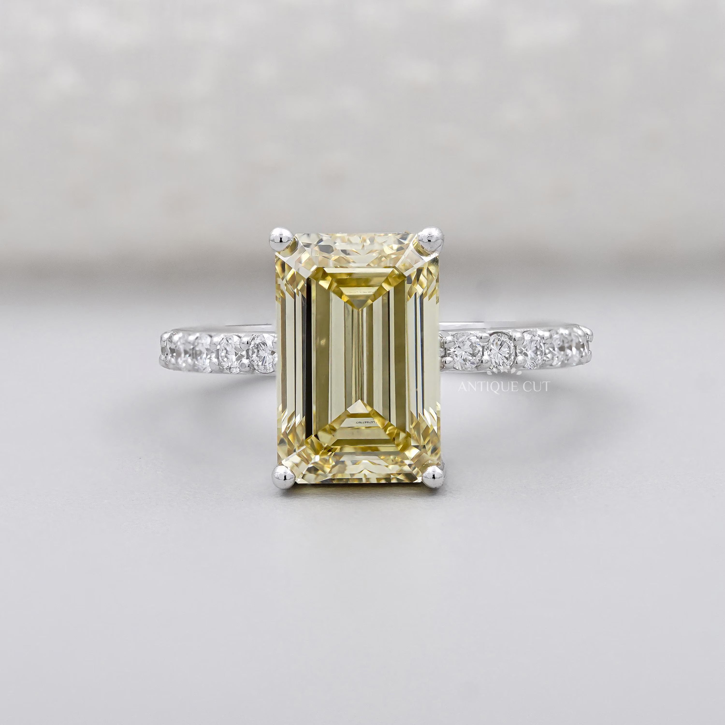 Emerald Cut Fancy Yellow Diamond Solitaire Ring with Round Pave Band IGI Certified