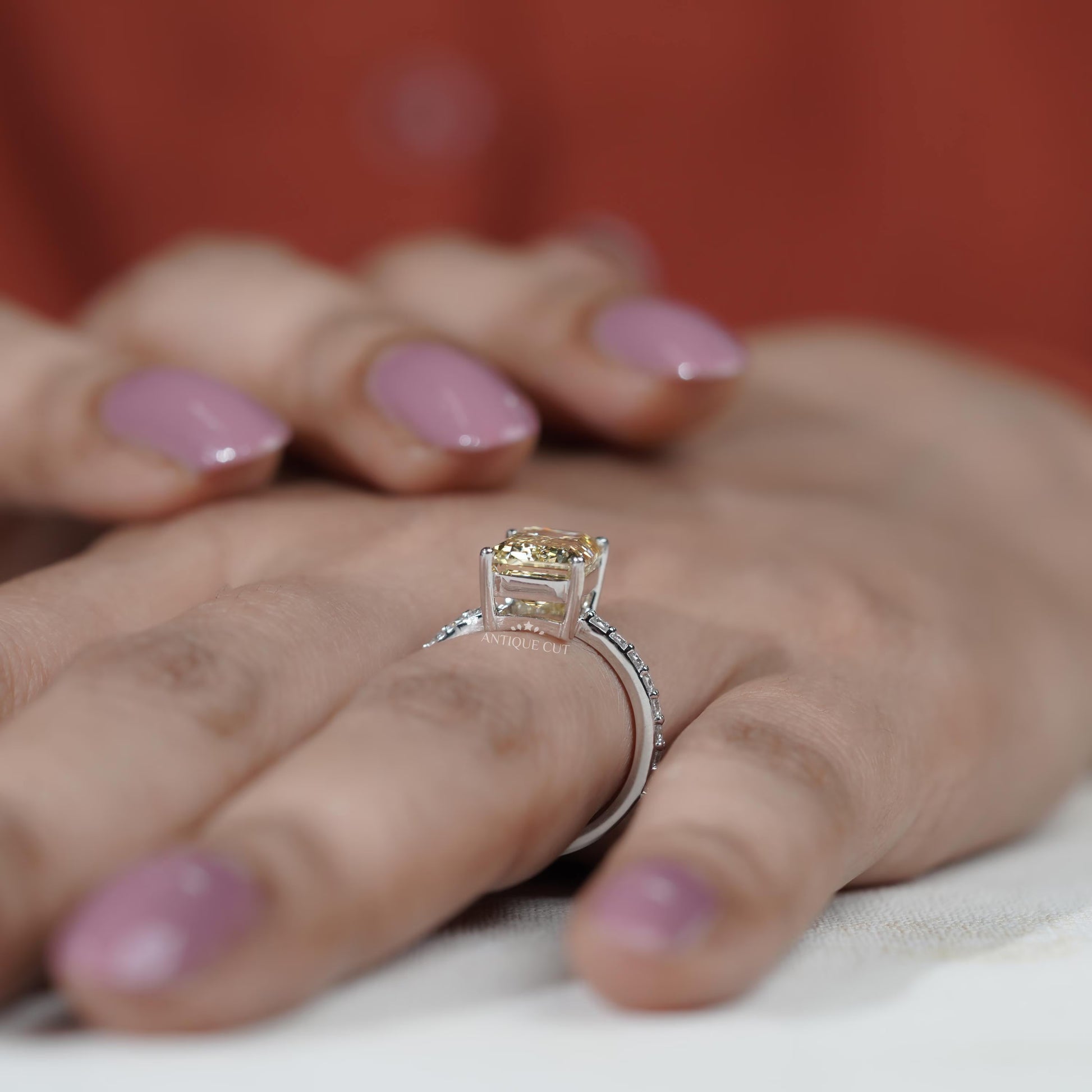 White gold emerald cut yellow diamond engagement ring