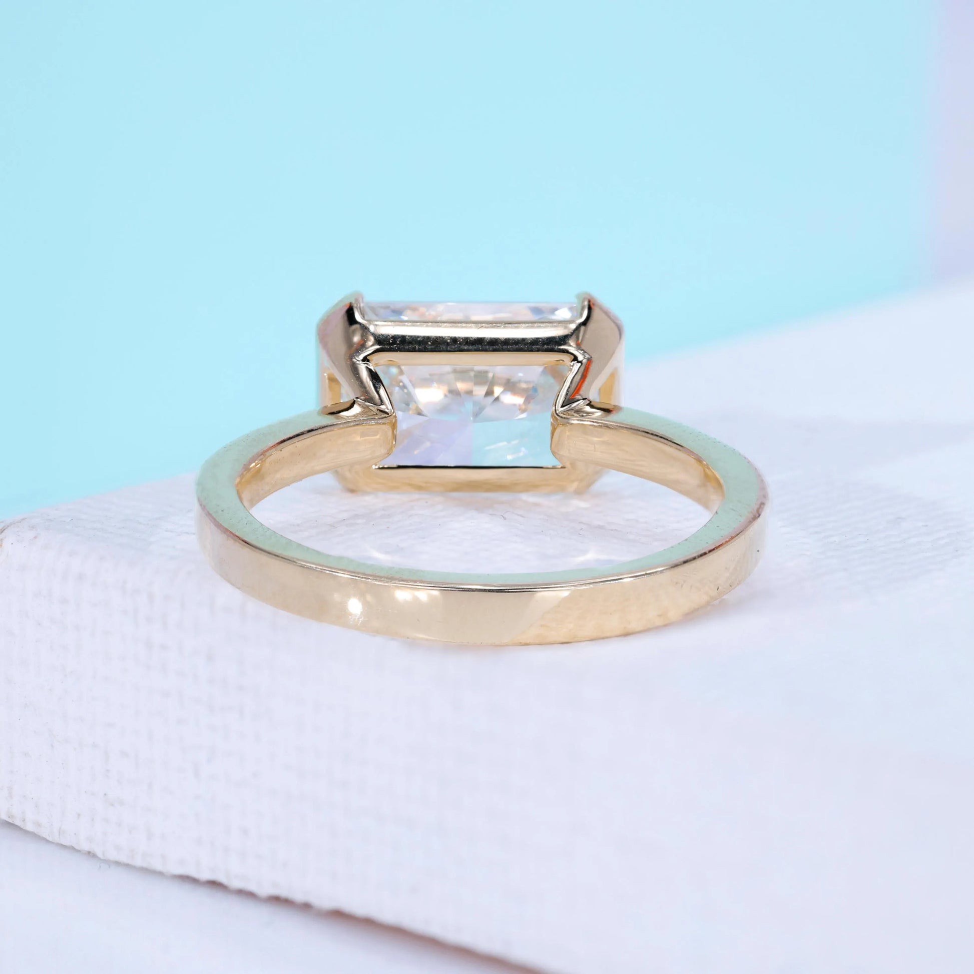 IGI certified east west radiant cut diamond ring in yellow gold