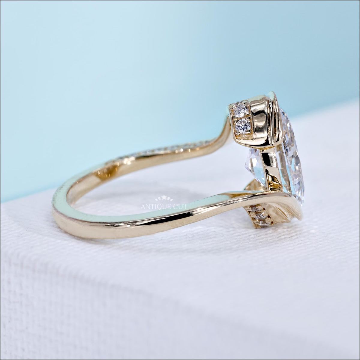Oval cut diamond bypass engagement ring with round side stone