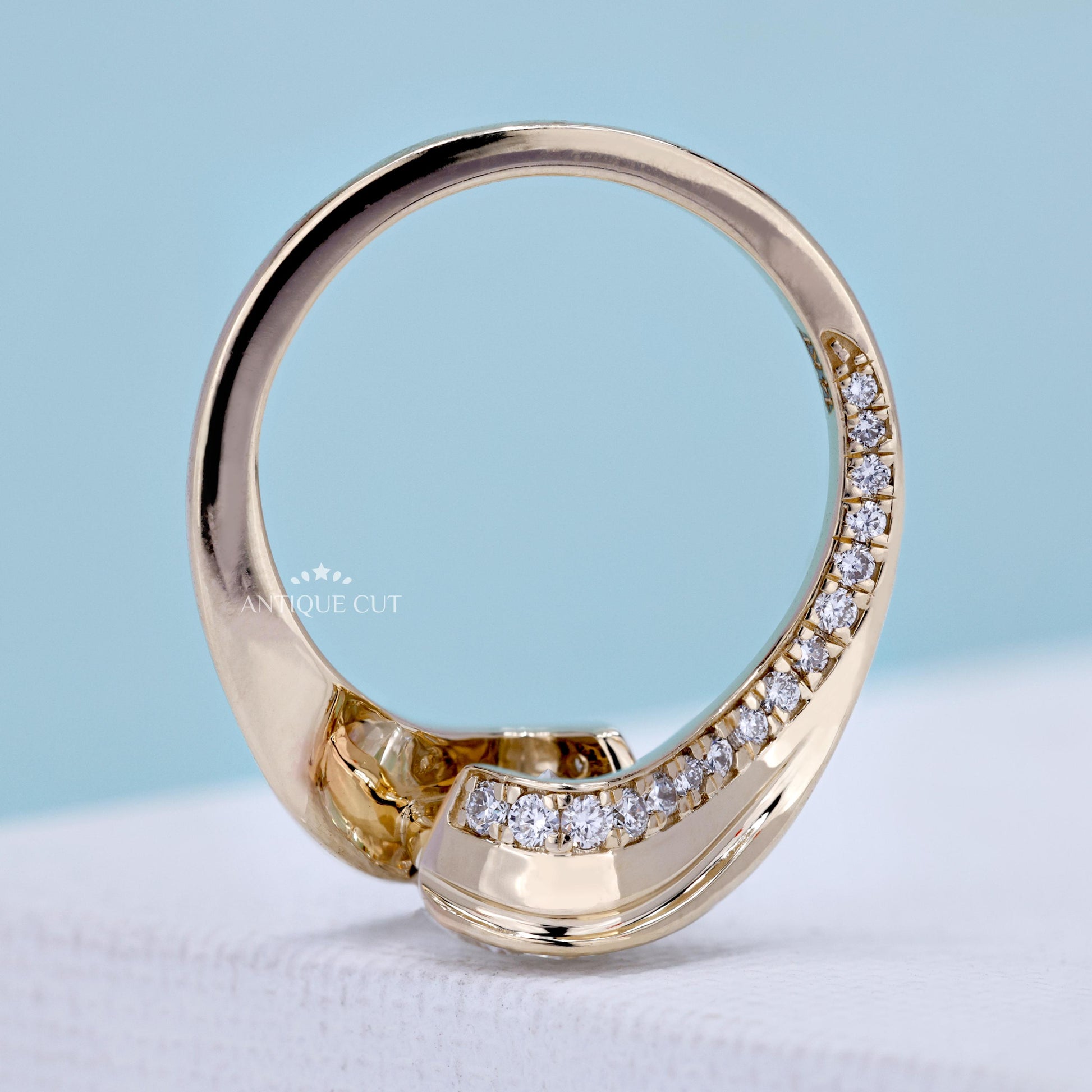 Yellow gold oval diamond ring featuring a bypass band design