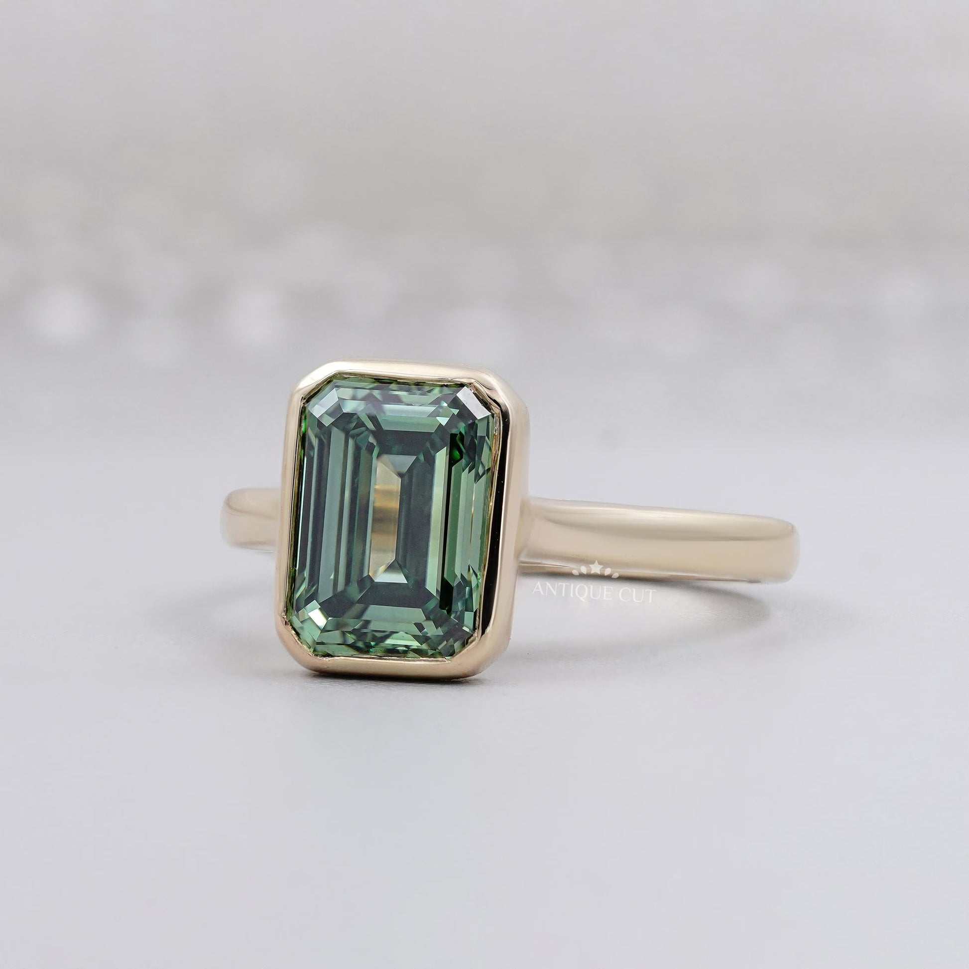Green sapphire emerald cut bezel engagement ring