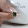 Emerald cut green sapphire proposal ring yellow gold