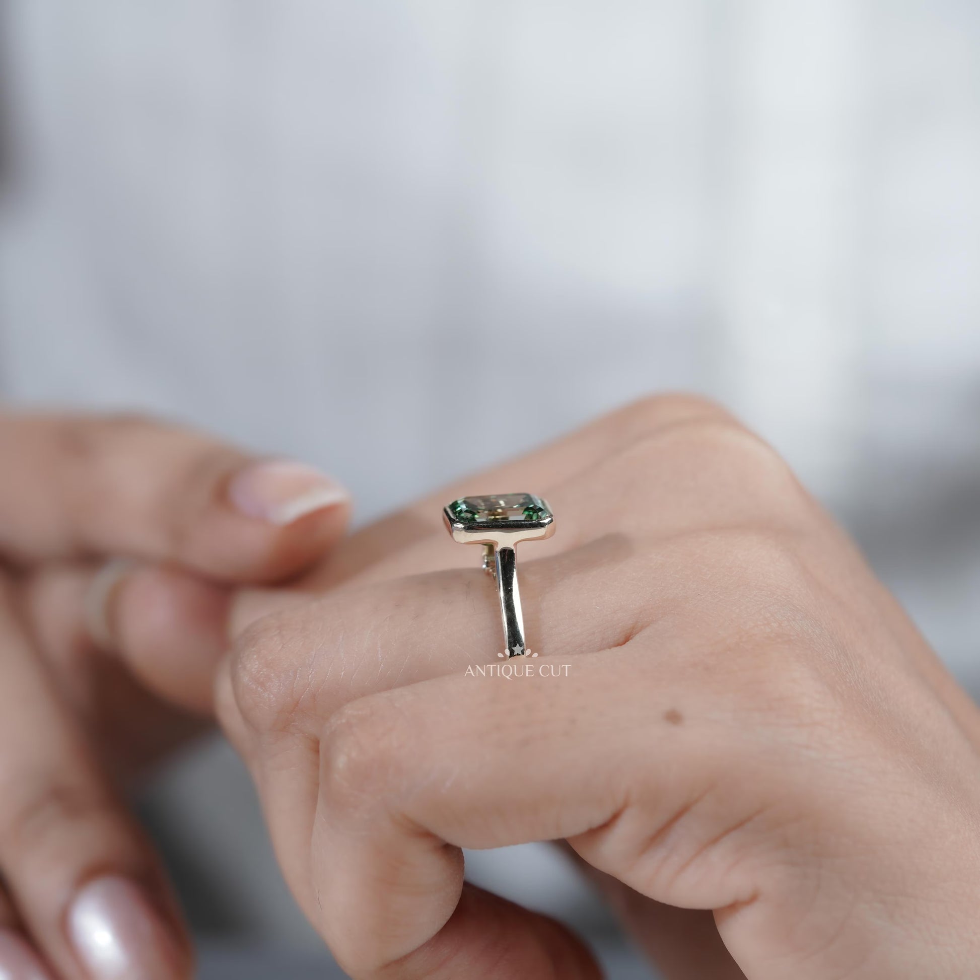 Modern solitaire green sapphire engagement ring