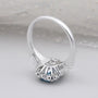 Blue topaz radiant cut halo engagement ring with baguette side stones