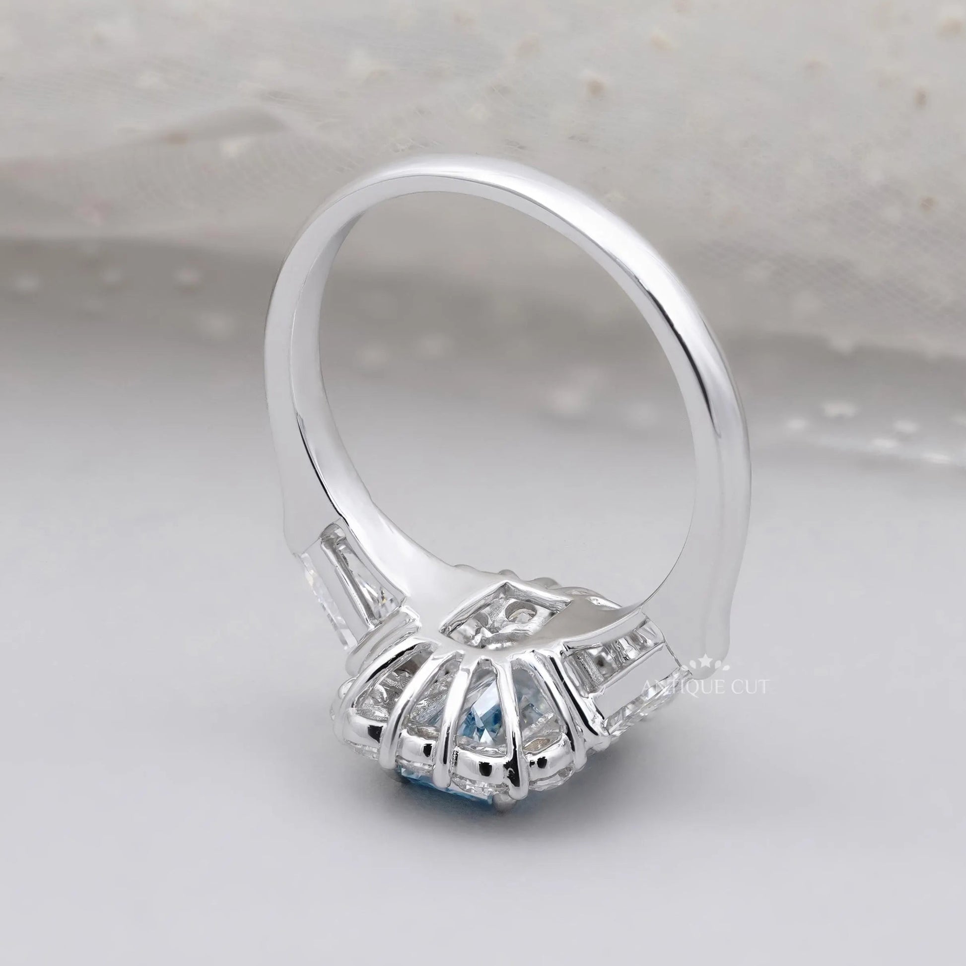 Blue topaz radiant cut halo engagement ring with baguette side stones