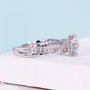 White gold floral halo engagement ring with bridge accent design