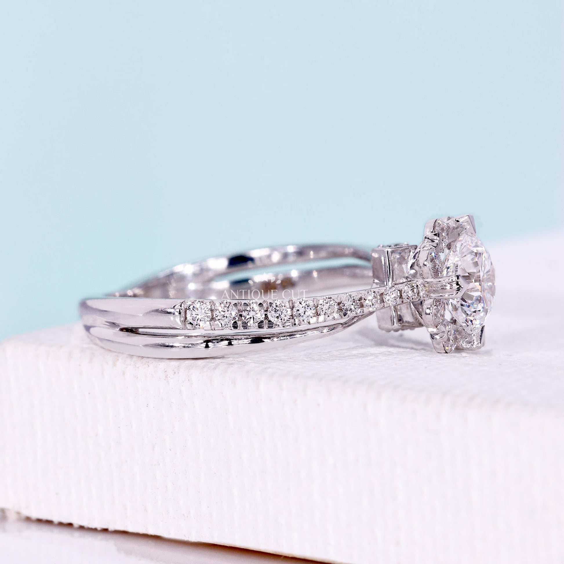 White gold floral halo engagement ring with bridge accent design