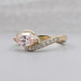 Pink marquise diamond ring with round side stones
