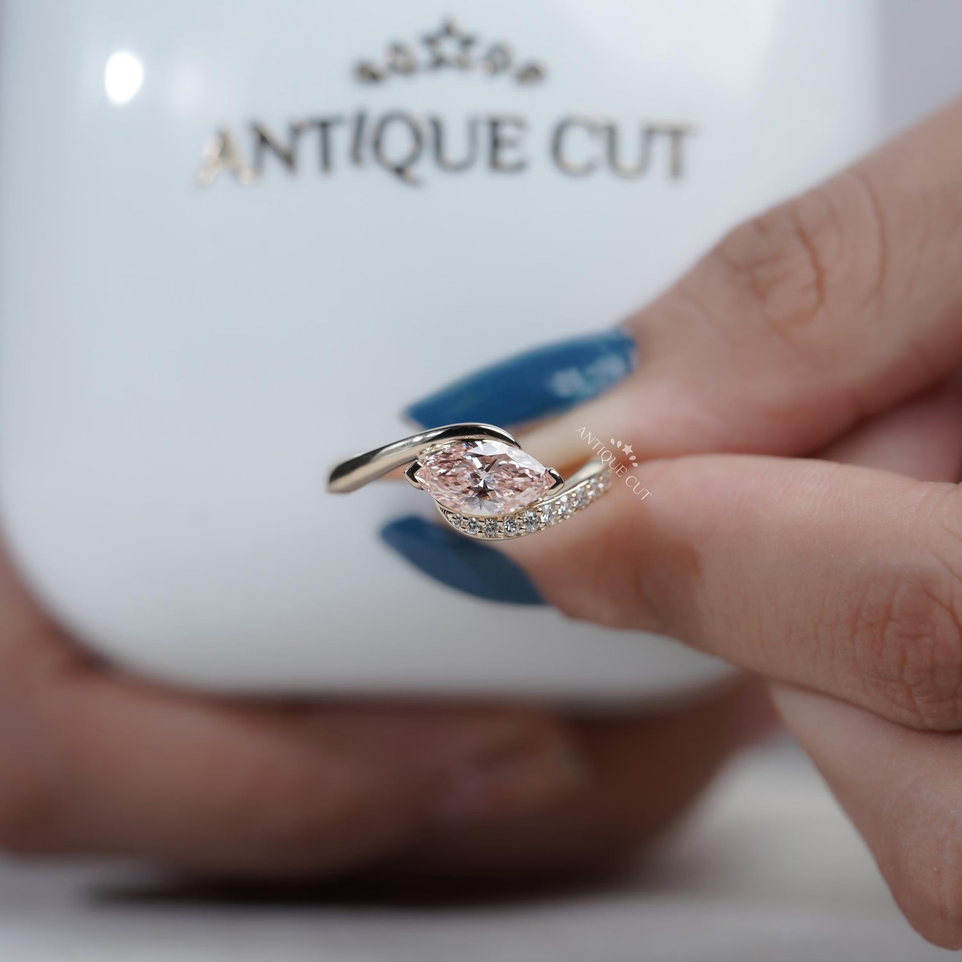 Modern bypass design engagement ring with pink marquise diamond